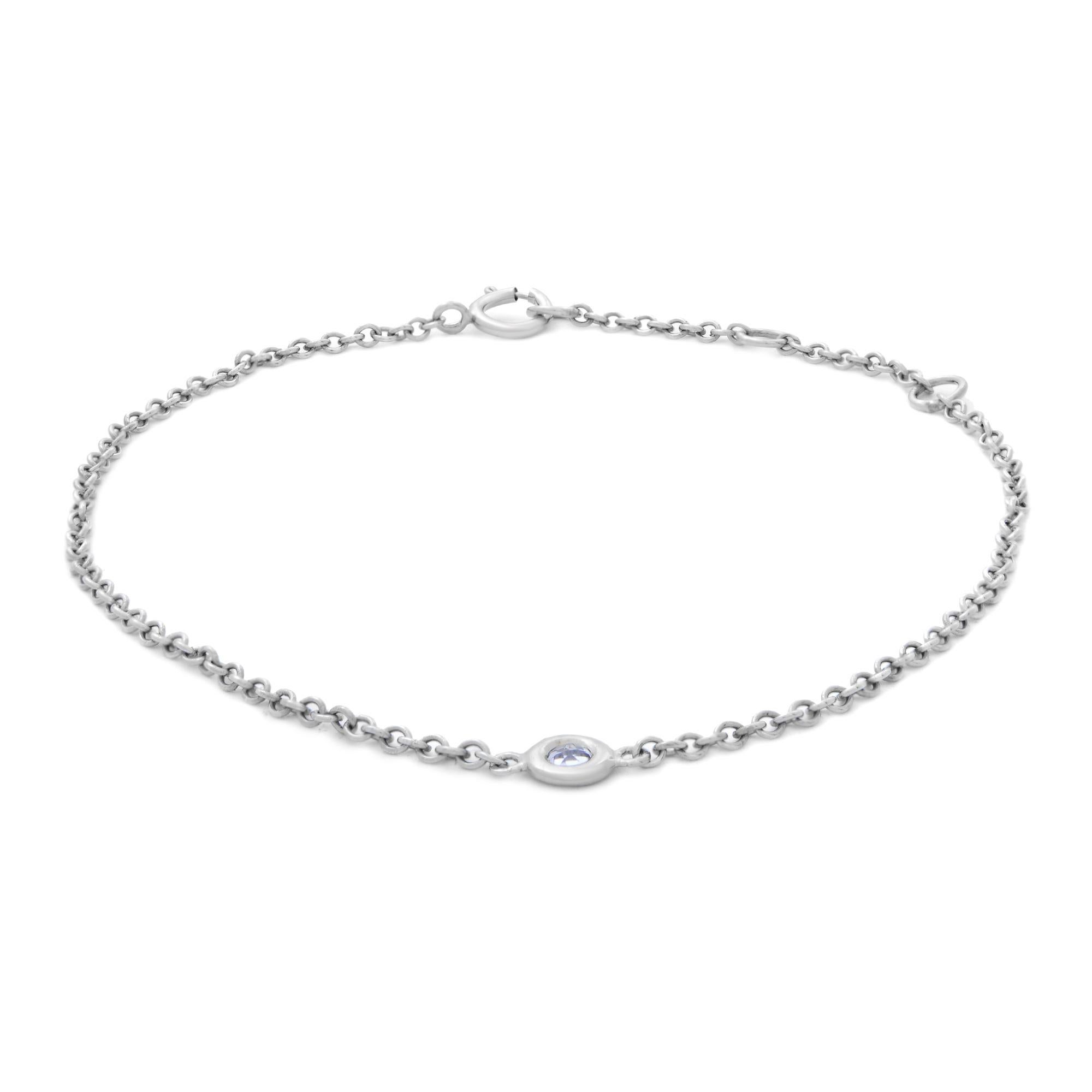 This 14k white gold bracelet features a delicate chain with a bezel set round cut Aquamarine gemstone charm. Tiny 15pt natural Aquamarine. March birthstone. Bracelet length: adjustable from 6.25-7.25 inches. We used the finest quality materials with