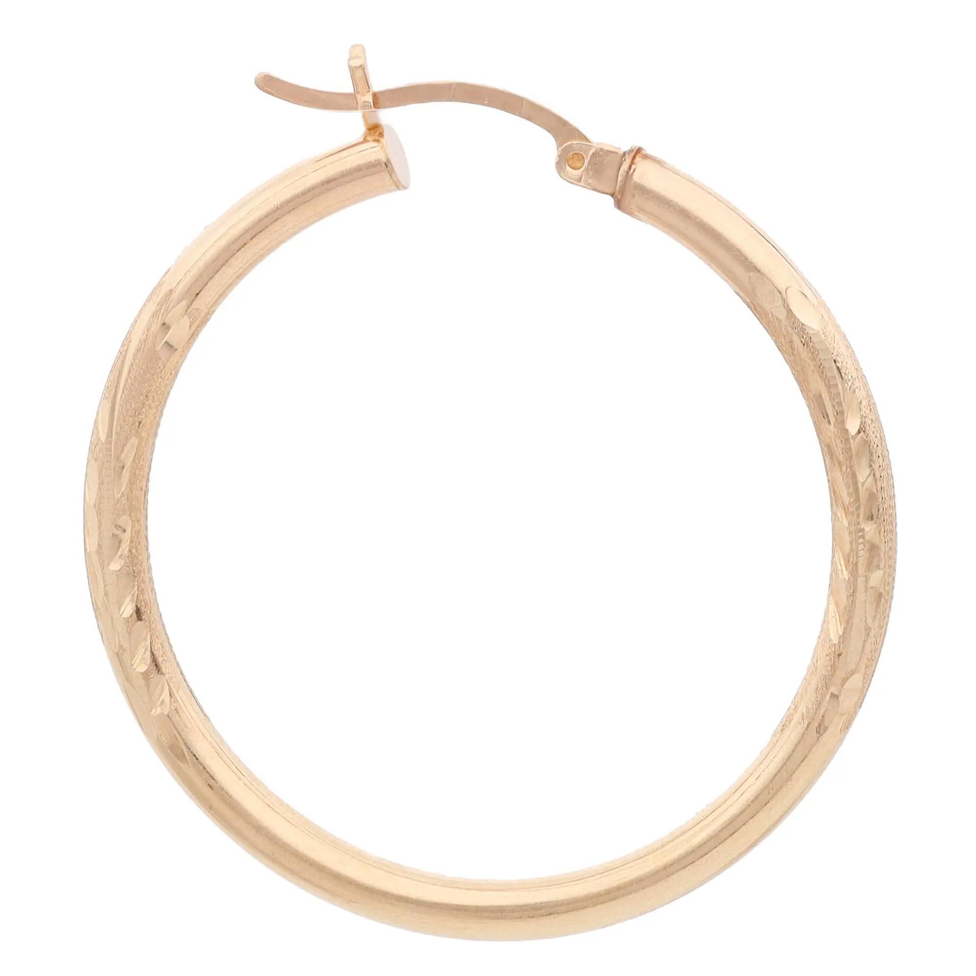 Elevate any attire with these dazzling textured hoop earrings. Crafted in lustrous 14K yellow gold. Earring length: 1.5 inches. Width: 2.9mm. Total weight: 3.94 grams. Comes with a presentable gift box.
