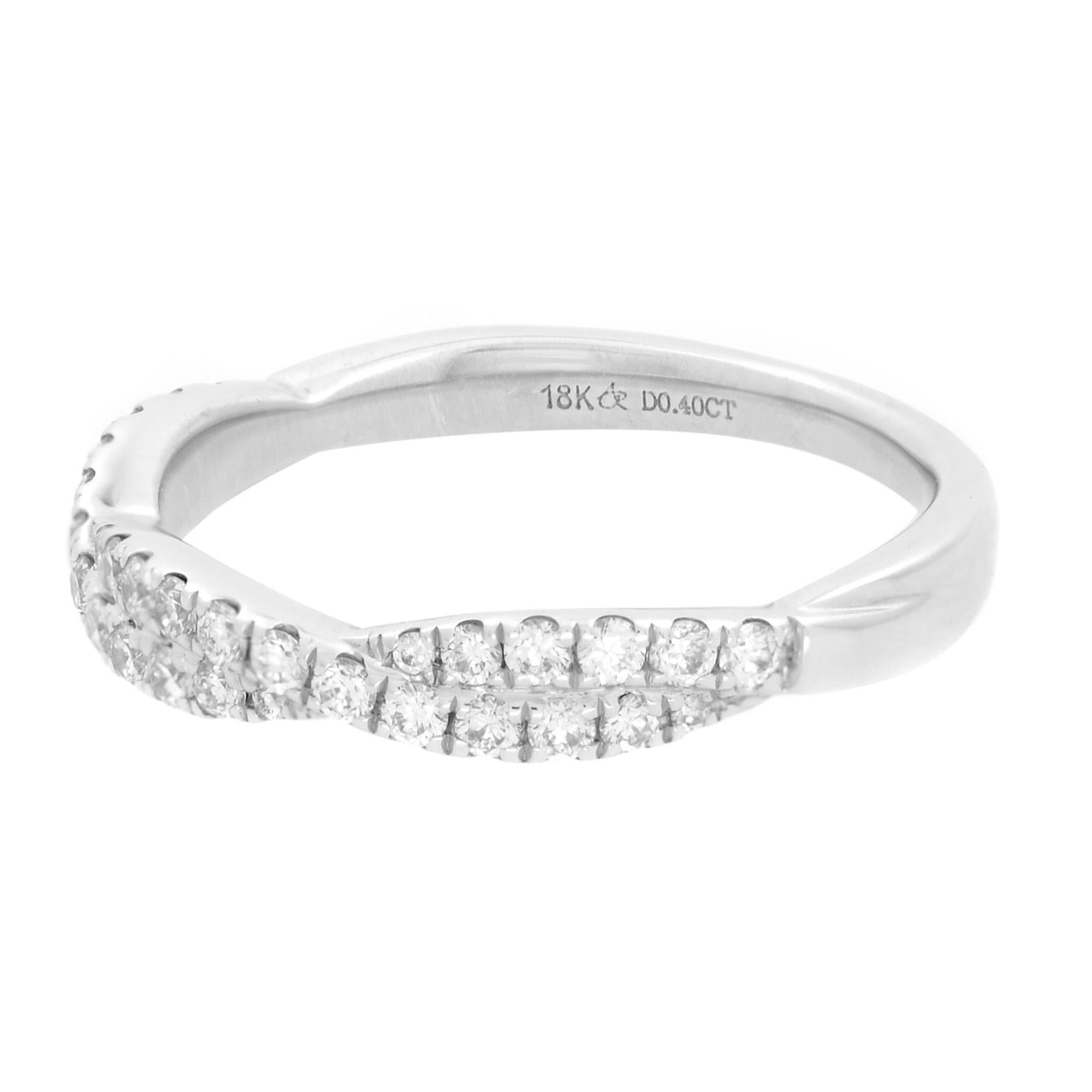 Simple and sophisticated, pavé twist diamond wedding ring. Crafted in bright 18k white gold, two rows of petite pavé-set round brilliant-cut diamonds intertwine for a timeless, eye-catching style. Carat weight: 0.40. Diamond color I and SI-I