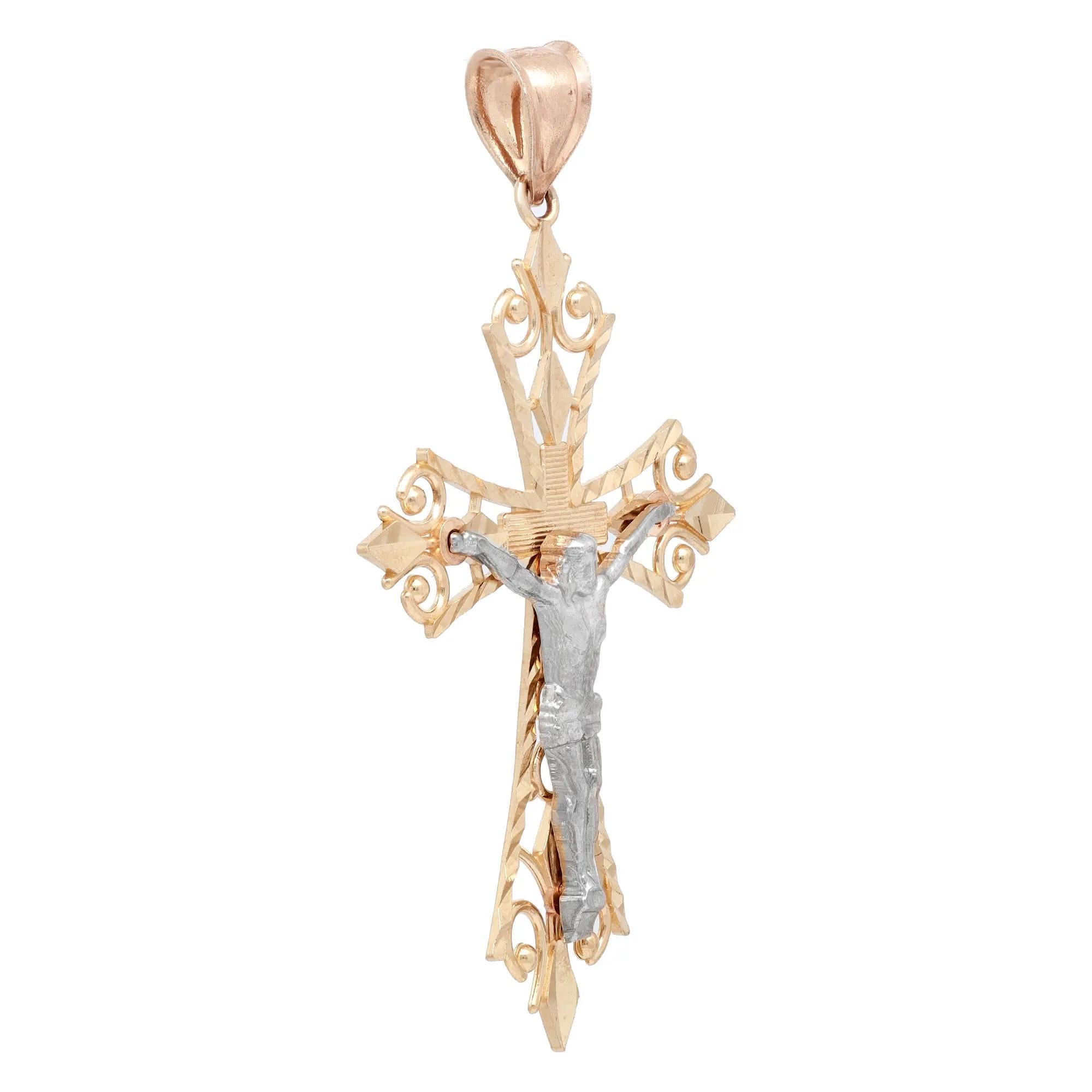 This meaningful cross pendant shines in lustrous 14K yellow and white gold. It features a crucifix filigree cross pendant in two tone gold. Pendant size: 2 inches x 1.2 inches. Total weight: 3.09 grams. Minimalist and stylish, perfect for everyday