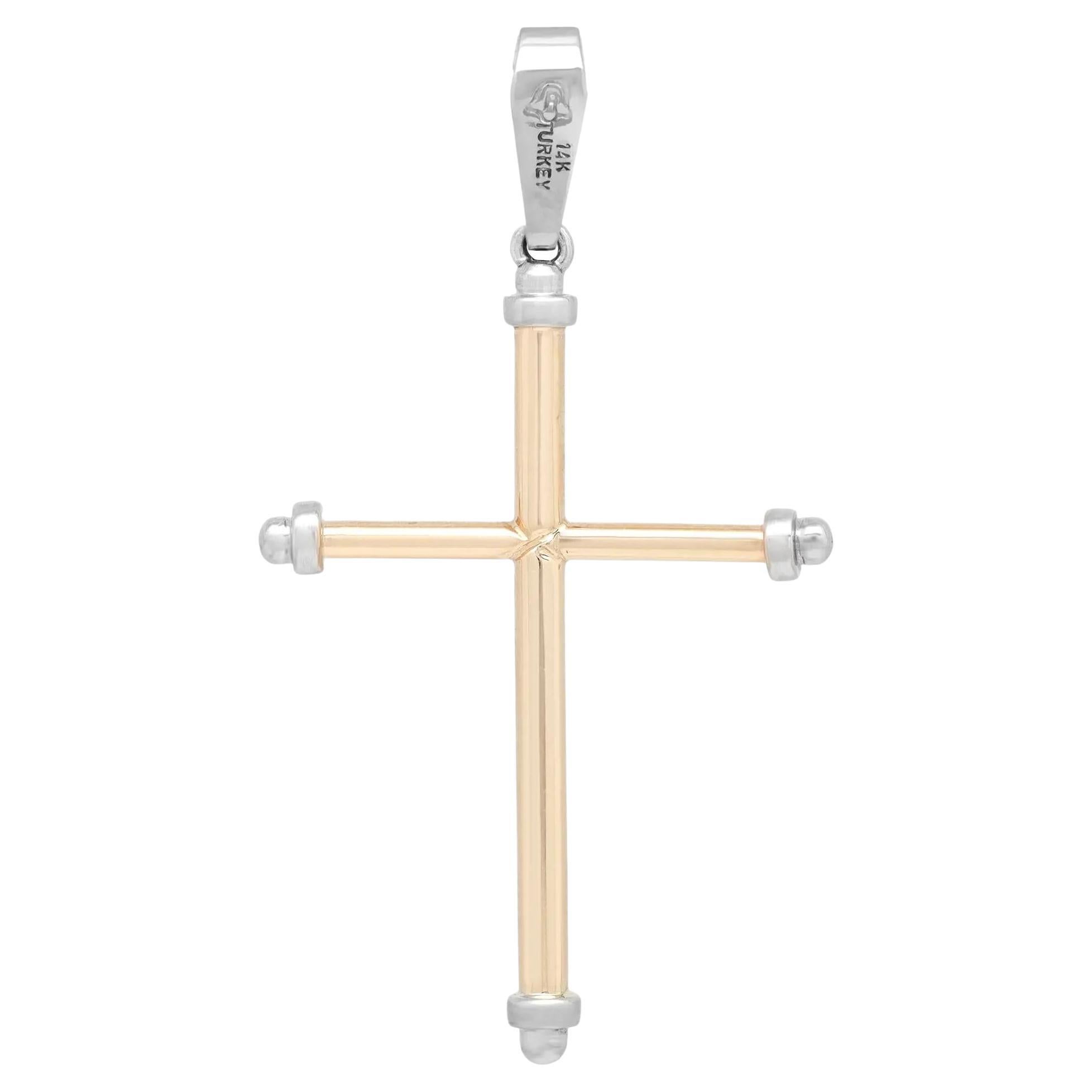 This meaningful cross pendant shines in lustrous 14K yellow and white gold. Features a rounded tube with white gold capped edges cross pendant. Pendant size: 2 inches x 1 inch. Total weight: 2.39 grams. Minimalist and stylish, perfect for everyday