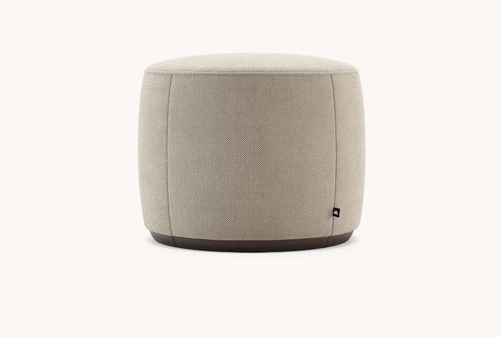 Rachel S pouf by Domkapa.
Materials: fabric, upholstery, Fumé stained beech. 
Dimensions: W 50 x D 50 x H 45 cm. 
Also available in different materials. 

Rachel pouf and its delicate round-shaped design is a piece made to bring extra comfort