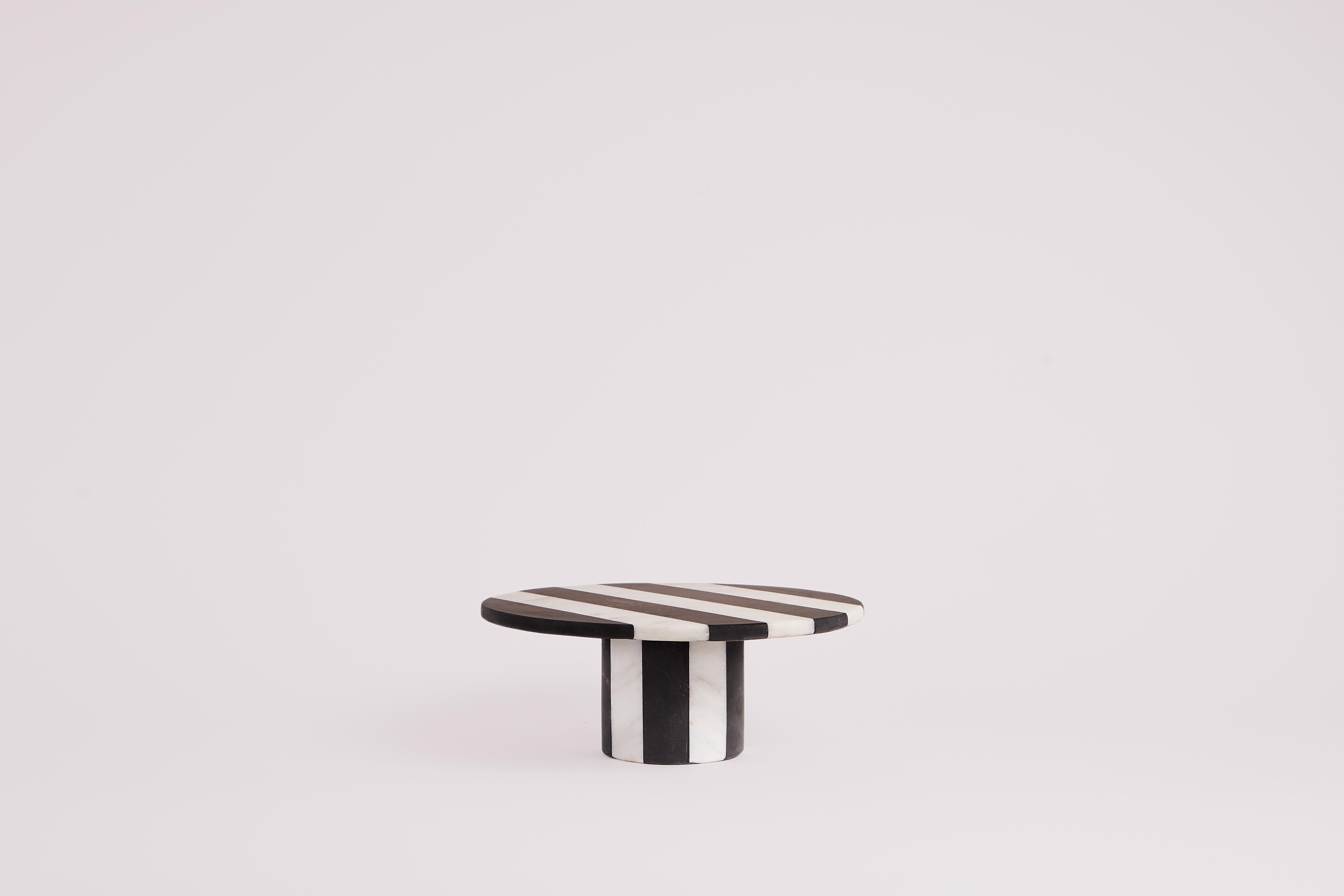The Rachel black and white marble server, designed by Studio Gaïa is an elegant and functional object that will bring a touch of sophistication to any table or display space. Made from high quality marble, this dish is carefully carved to deliver a