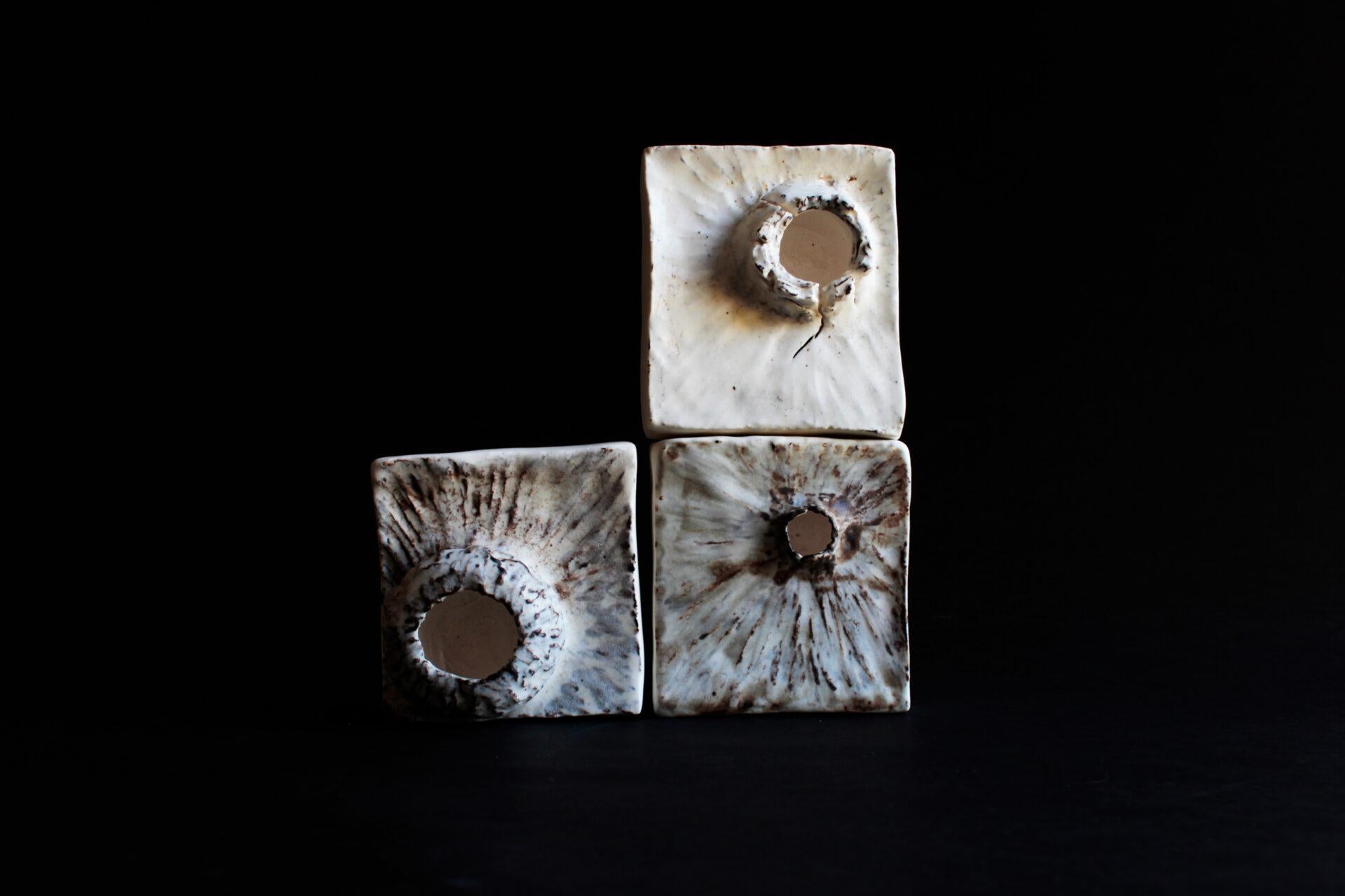 These solid blocks of porcelain represent the repetitive nature of resilience and perseverance, positive and negative space, all with the acknowledgment that no two outcomes will ever be the same. The pushing and pulling the clay showing the