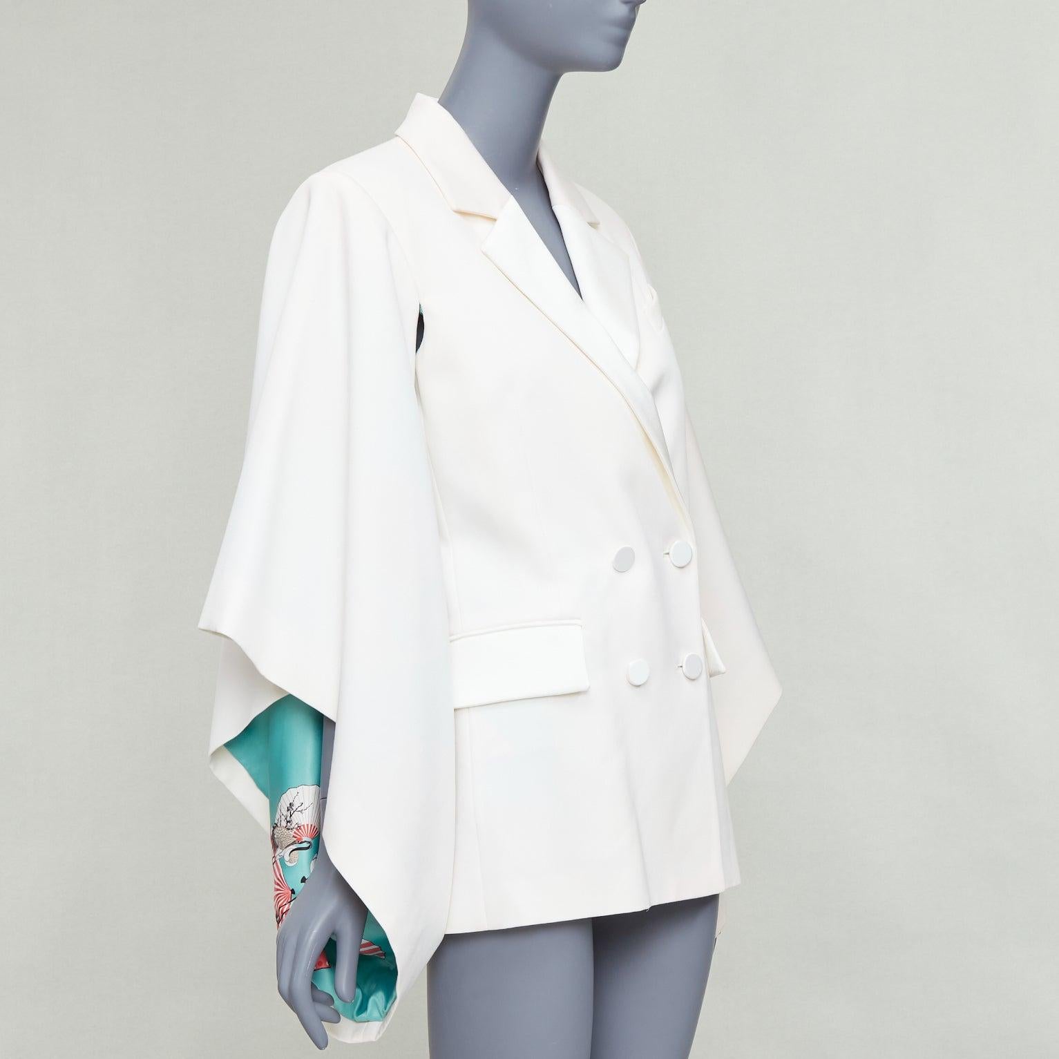 RACIL Kyoto Kimono cream satin print lined cape sleeve tuxedo jacket
Reference: JACG/A00177
Brand: Racil
Material: Feels like wool
Color: Cream, White
Pattern: Solid
Closure: Button
Lining: Multicolour Fabric
Extra Details: Racil cape jacket with