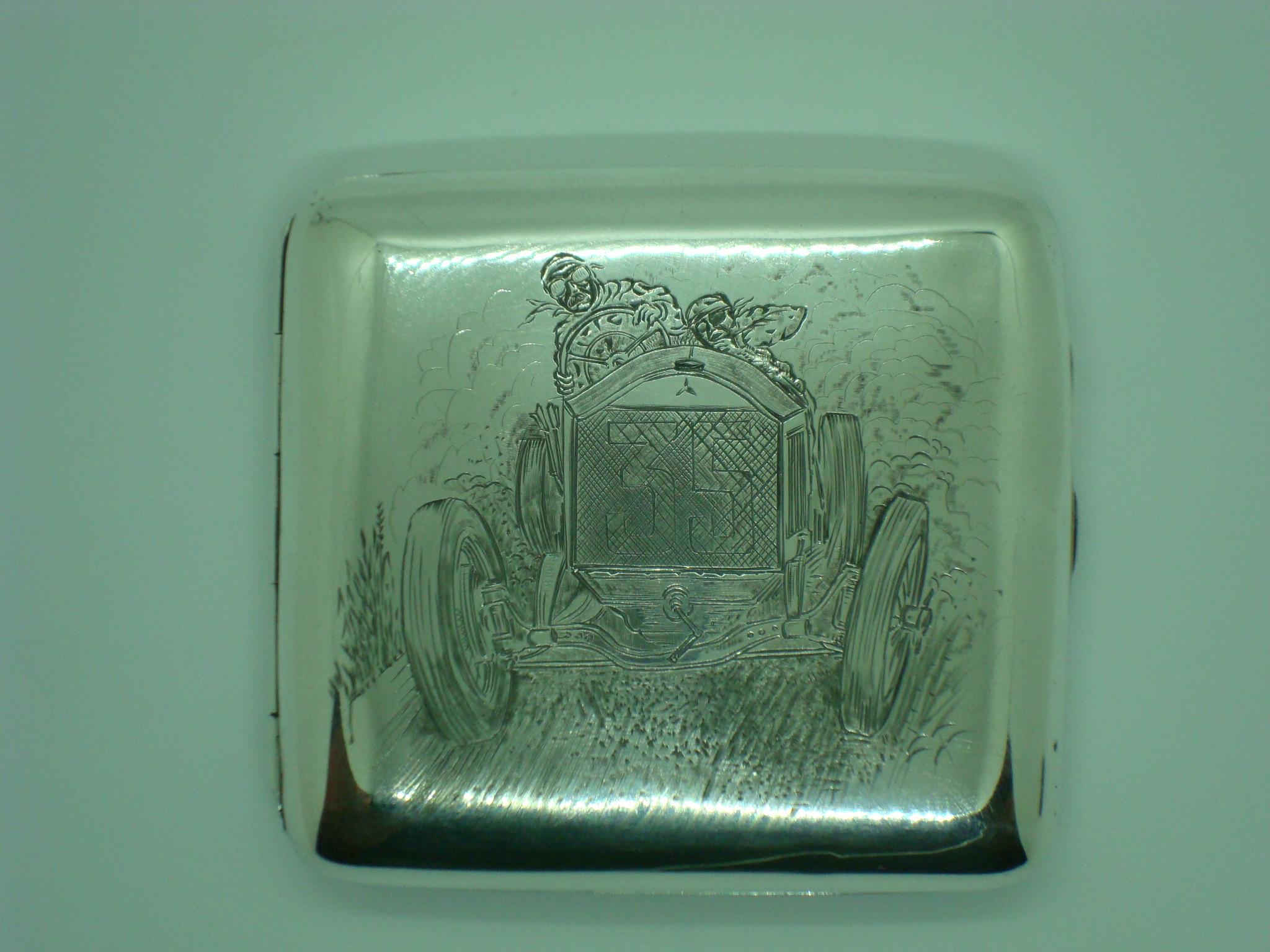 A magnificent and extremely rare sterling silver engraved cigarette case depicting a stylized Racing car. The car has the emblem of Mercedes Benz.
Marked UK Birmingham Sterling silver, Henry Clifford Davis 1918.
A beautiful and exceptionally rare