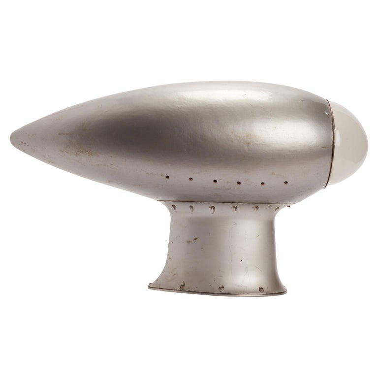 A fine example of reinterpretation and realization from an old element. A radar from an American airplane have been reused as sconce. The structure is made out of painted wood, gray color, with the top element, made out of curve frosted glass. USA ,