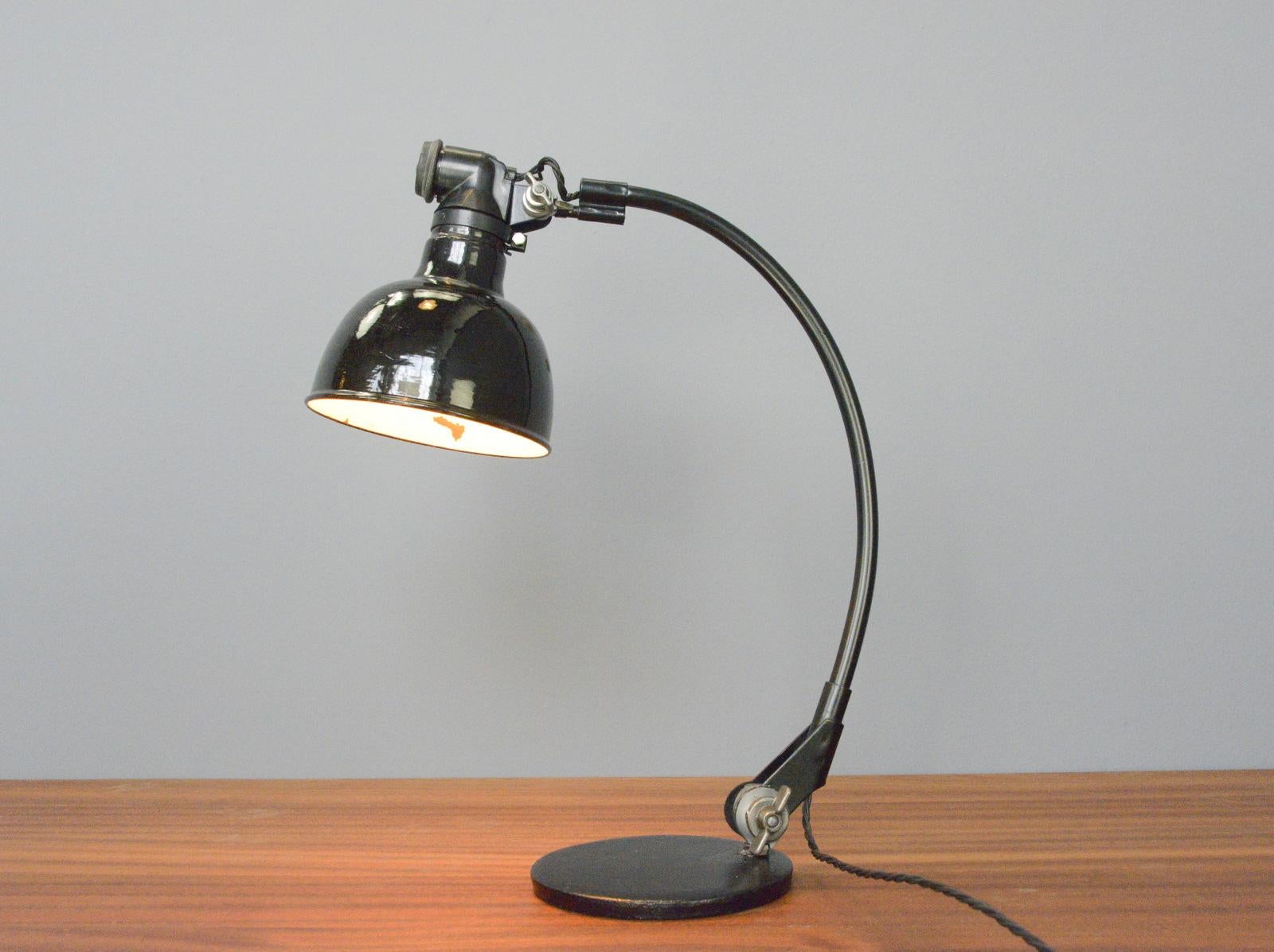 Rademacher table lamp, Circa 1920s.

- Vitreous black enamel shade
- Articulated curved arm
- Cast iron base
- Made by Ernst Rademacher, Dusseldorf
- German ~ 1920s
- 50cm tall x 40cm deep x 16cm wide

Rademacher

Founded as a company in
