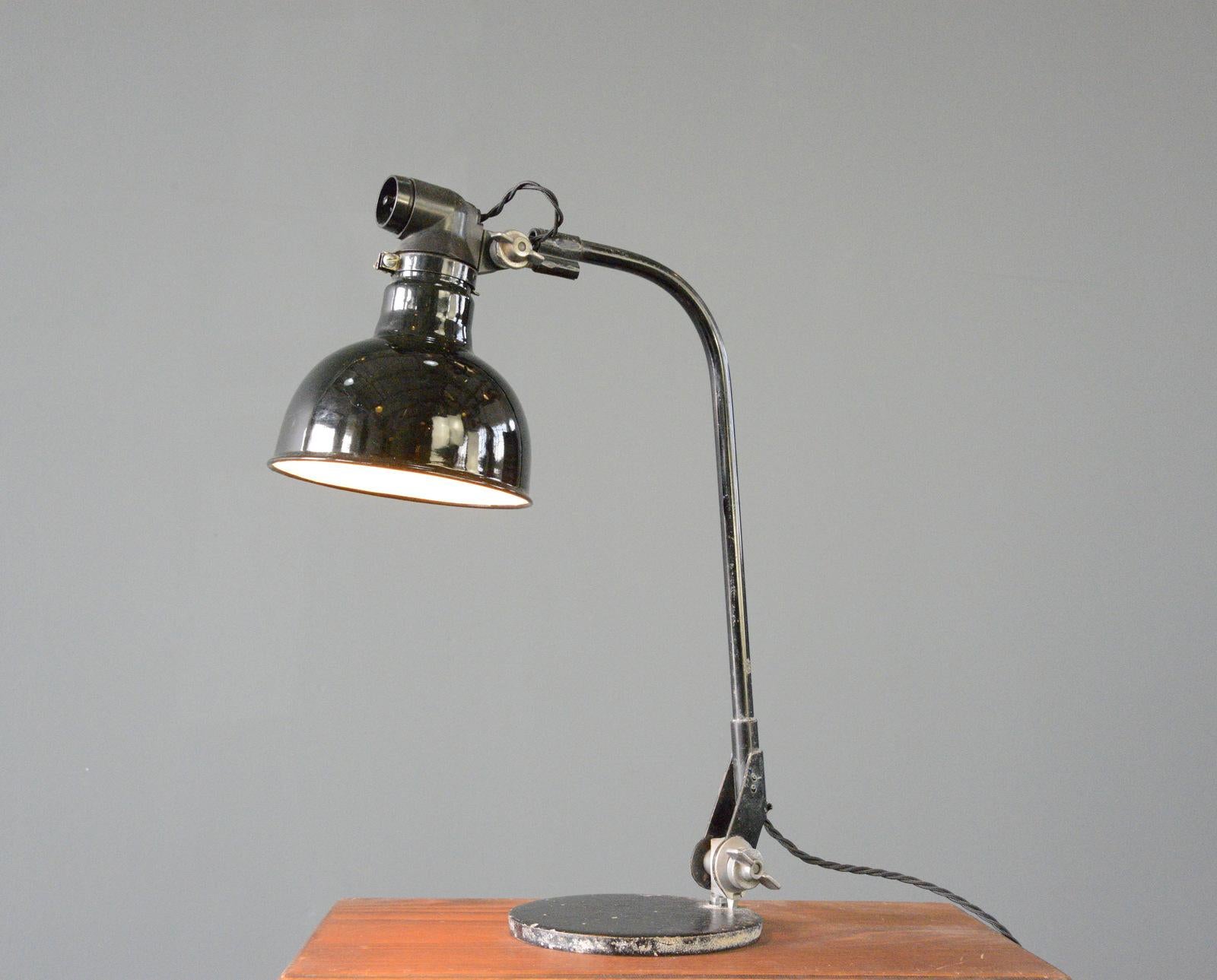 Rademacher Table Lamp Circa 1920s

- Vitreous black enamel shade
- Articulated curved arm
- Cast iron base
- Made by Ernst Rademacher, Dusseldorf
- German ~ 1920s
- 50cm tall x 40cm deep x 16cm wide

Rademacher

Founded as a company in 1914 by Ernst