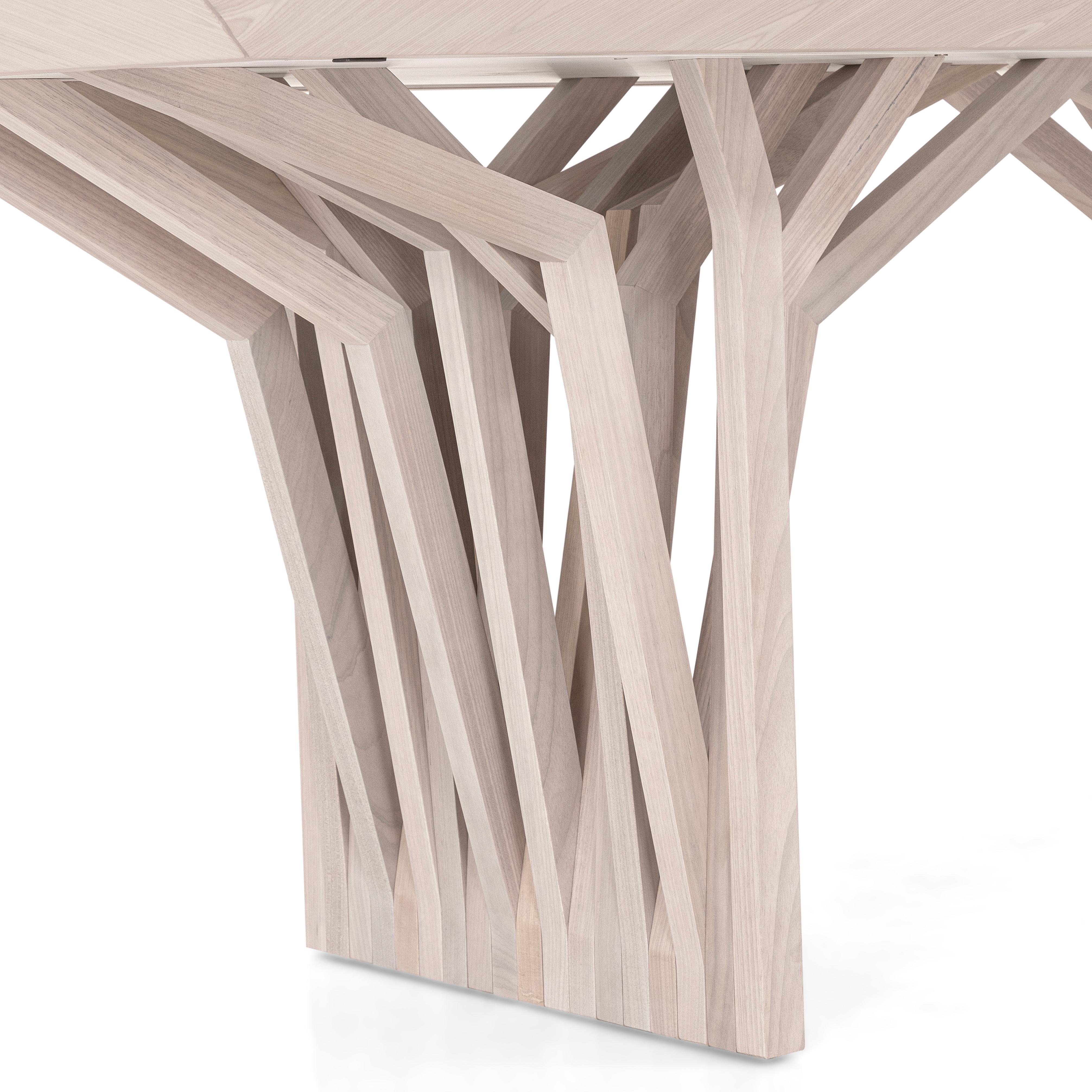 The Radi dining table by Uultis captures the poetry of nature in a minimalist, architectural silhouette. With a generous 118-inch top finished in Dover Oak veneer, this table features a sculptural dual-base design that evokes aerial tree roots or
