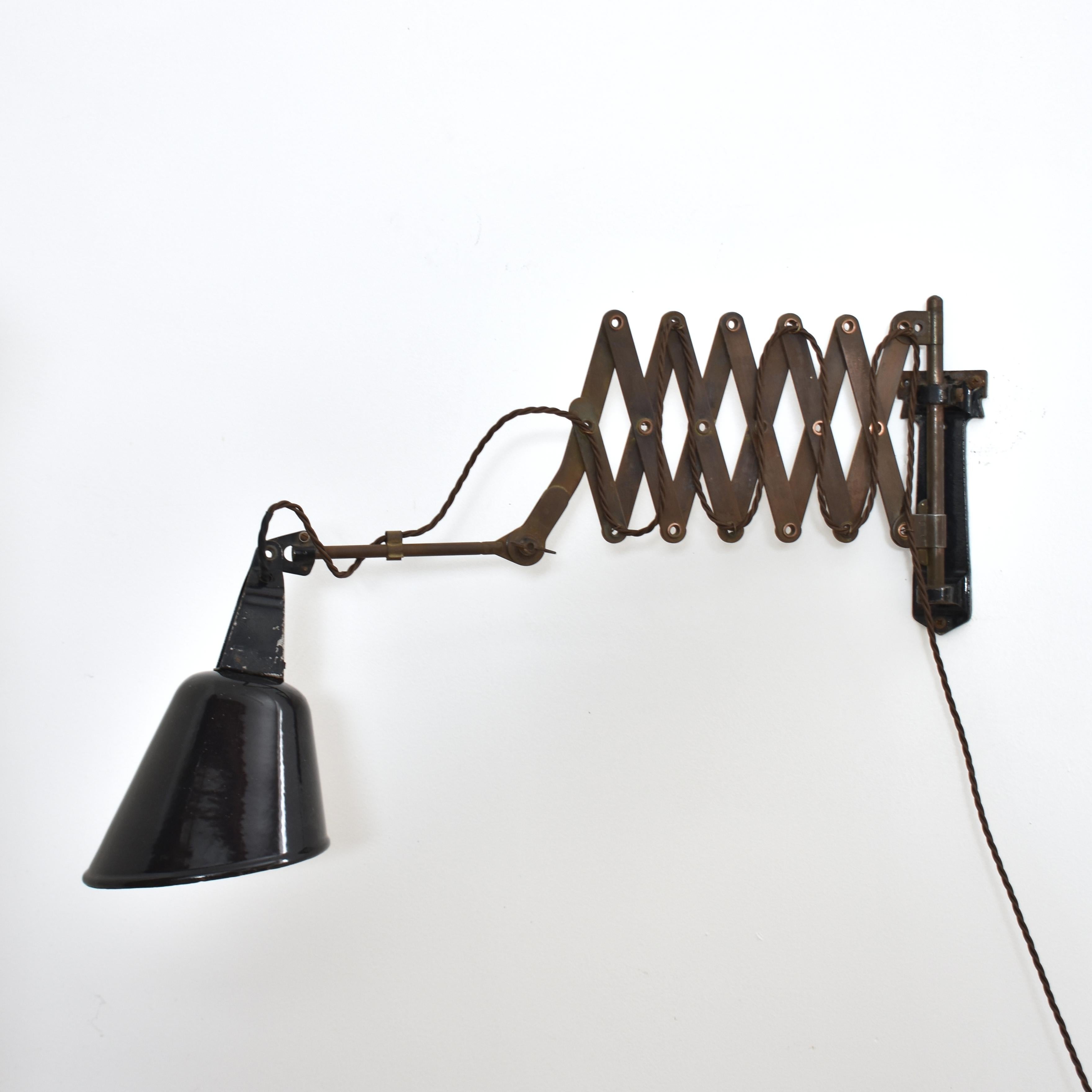 Radialite Vintage Scheren-Wandleuchte von Walligraph

Eine Scherenwandleuchte im Vintage-Stil mit einem schwarzen Aluminiumschirm. Die Leuchte hat einen Doppelscherenmechanismus aus Stahl, der aus- und einfahren kann. Die Position des Schirms kann