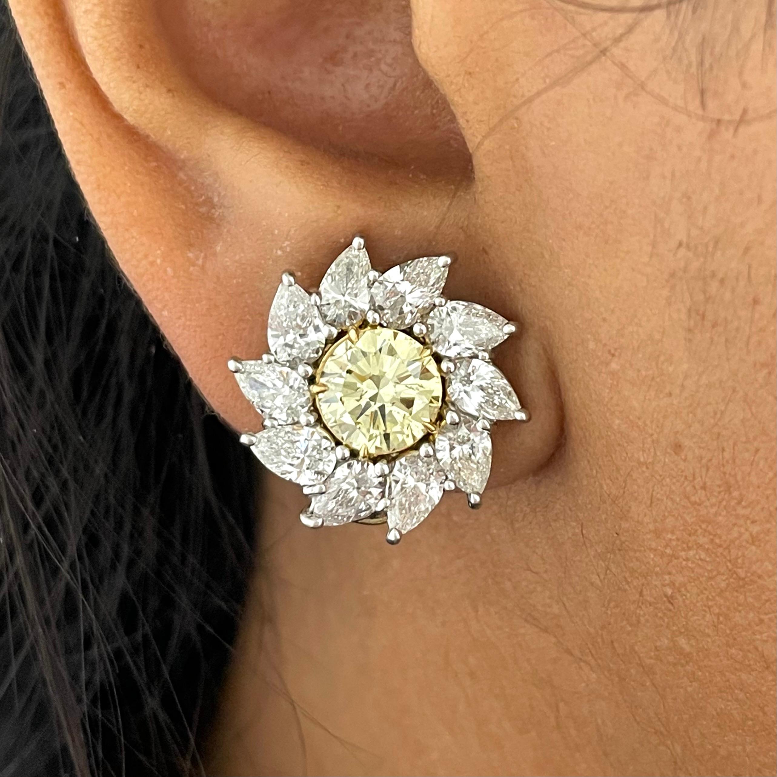 Hand crafted with platinum and yellow gold, these gorgeous yellow and white diamond earrings with round and pear shape diamonds are just incredible. In addition to being worn as studs, they are also adaptable so that a solitaire or a chandelier can