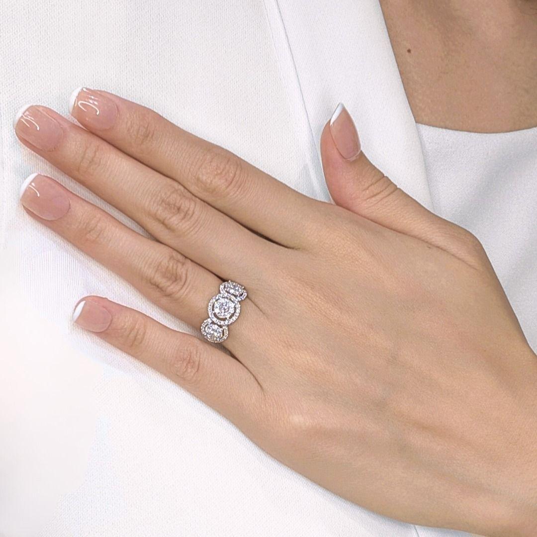 Prepare to be captivated by the breathtaking brilliance of this radiant cluster ring, meticulously crafted in luxurious 18K white gold. A stunning constellation of seventy-seven natural round brilliant diamonds, totaling an impressive 0.85ct, forms