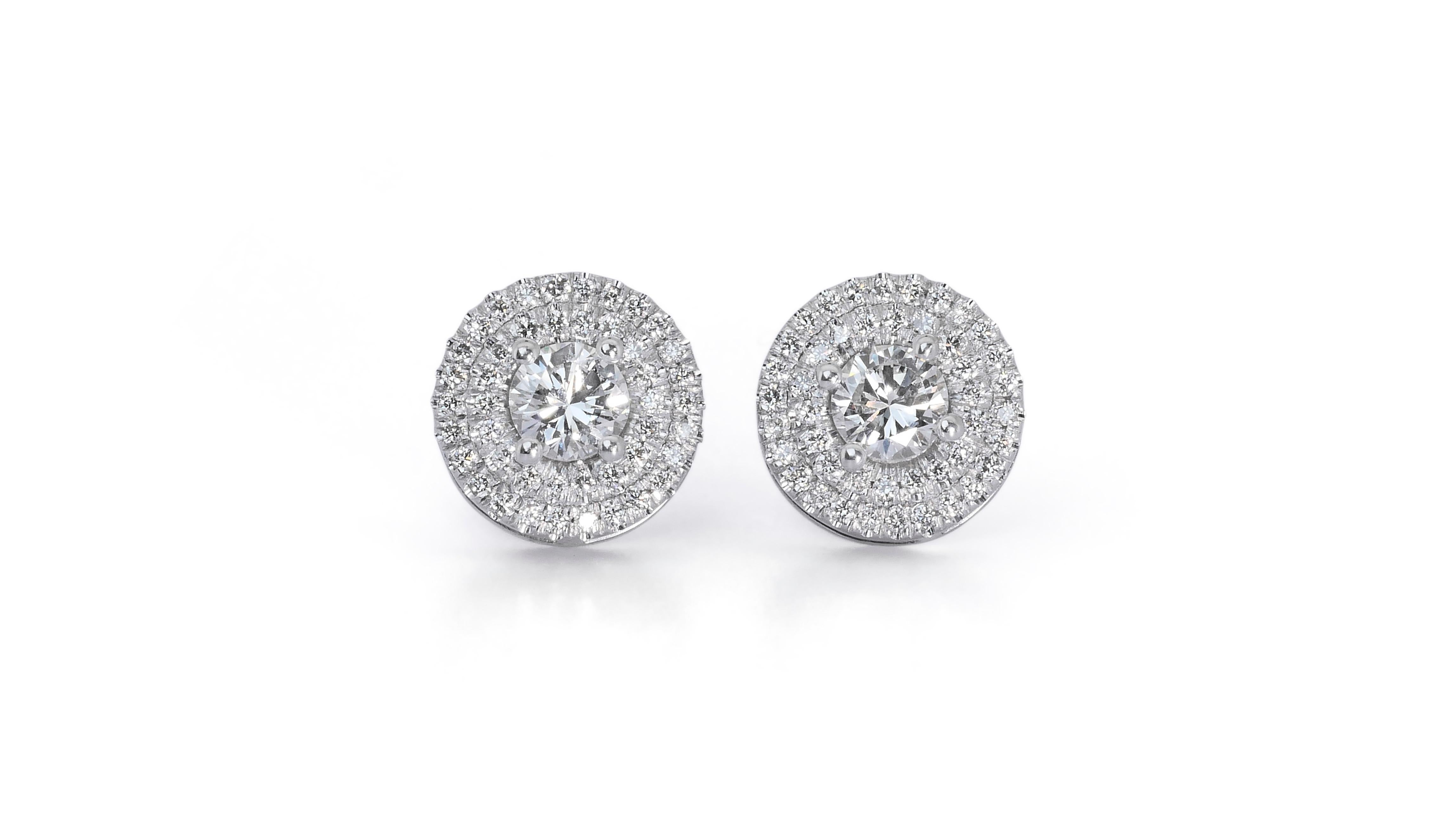 Radiant 1.20ct Diamonds Halo Stud Earrings in 18k White Gold - GIA Certified

These exquisite halo diamond earrings, crafted in fine 18k white gold, epitomize sophistication and timeless style. Each earring features a central round diamond weighing