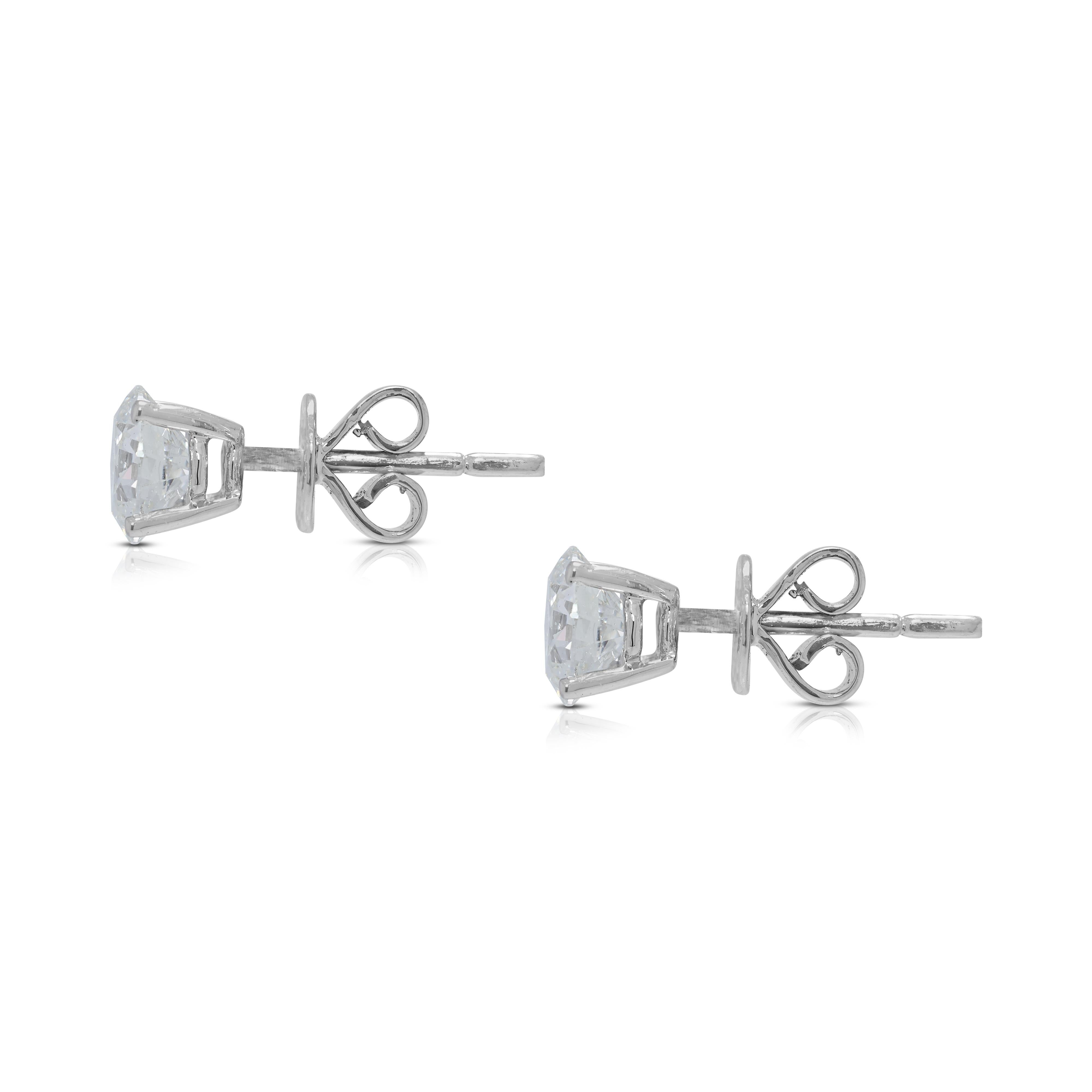 Captivating brilliance of certified diamonds, a testament to exceptional quality and undeniable sparkle. These new 18K white gold stud earrings feature two stunning round brilliant diamonds, totaling 1.61ct, each boasting an H color and SI1 clarity,