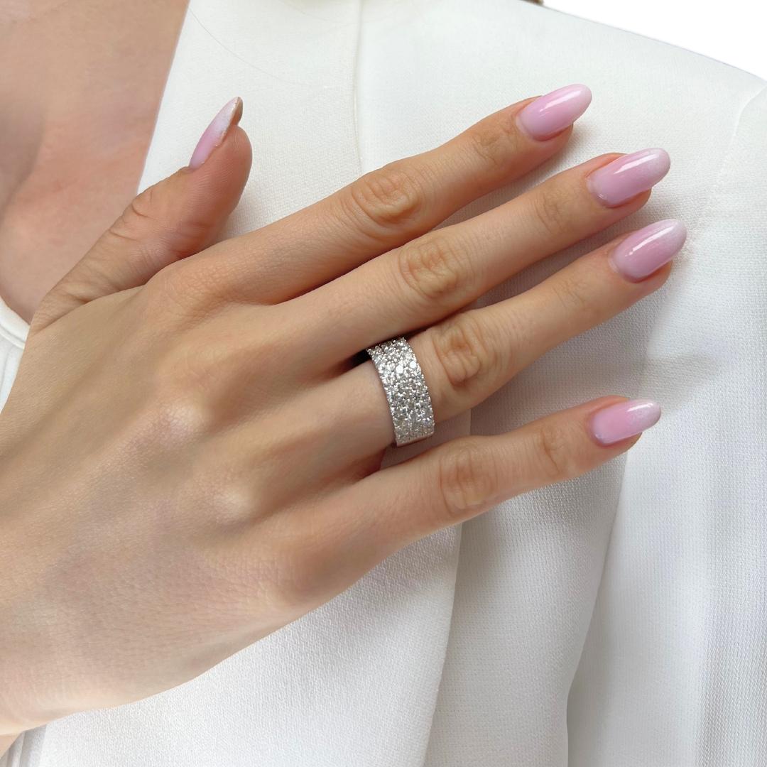 Enhance your style with this exquisite 14K white gold band ring, adorned with 42 round diamonds totaling 1.85 carats. Expertly cut to a good grade, these diamonds radiate beauty in every movement. It comes with an IGI certification, this ring