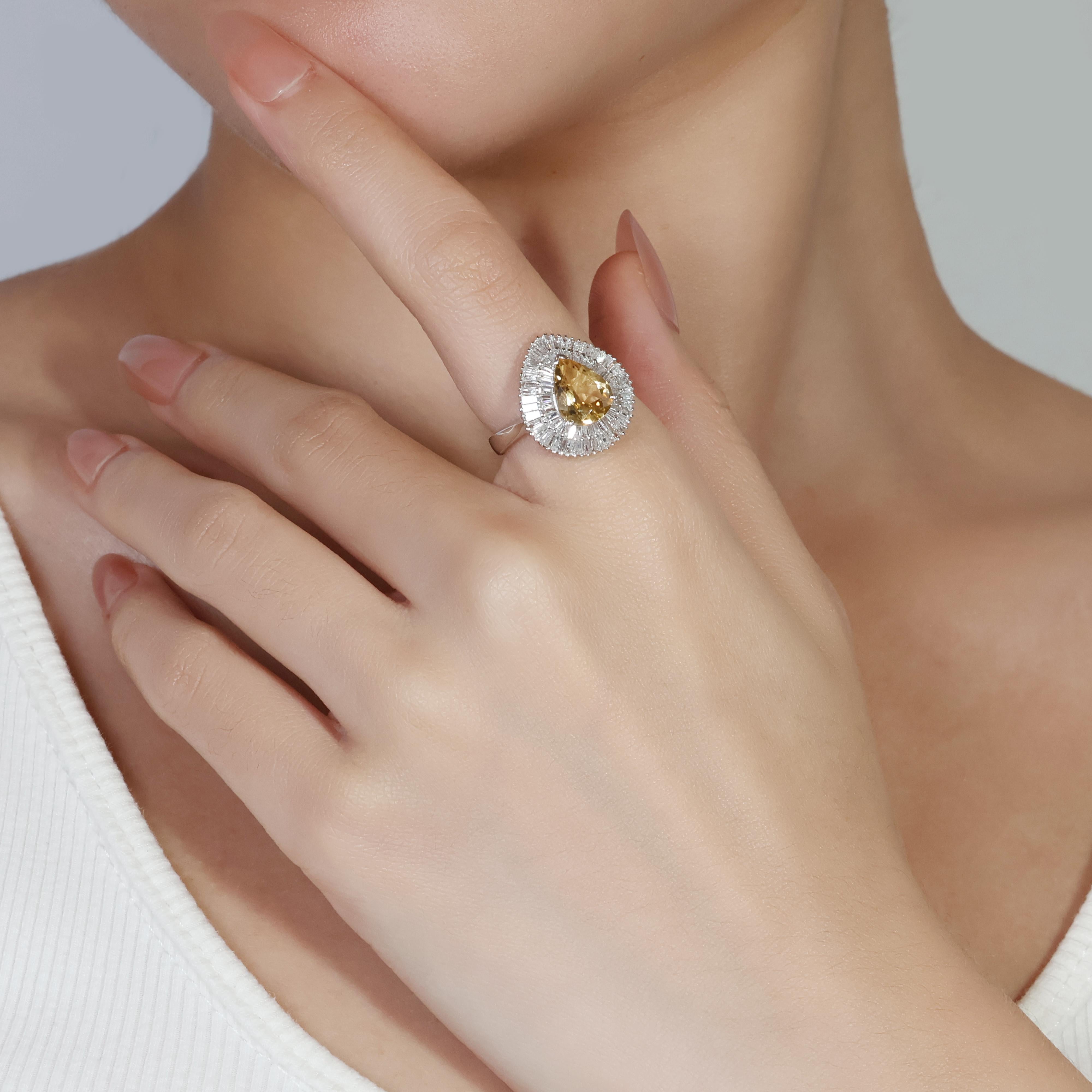 Unveiling a radiant 18k white gold ring featuring a mesmerizing 1.90-carat pear-shaped citrine as its centerpiece. Adding a touch of sparkle are 80 dazzling taper diamonds totaling 0.56 carats.  Graded H for near colorless and SI for clarity, these