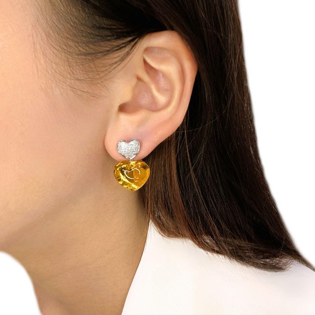 A love story told in gemstones—these heart-shaped citrine beauties radiate warmth with 25.9 carats of fiery orange brilliance, embraced by a constellation of 80 sparkling diamonds. The golden glow of citrine symbolizes joy, prosperity, and passion,