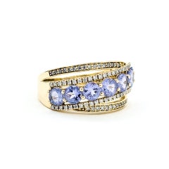 Anello con tanzanite e diamanti incrociati radianti in 14 carati