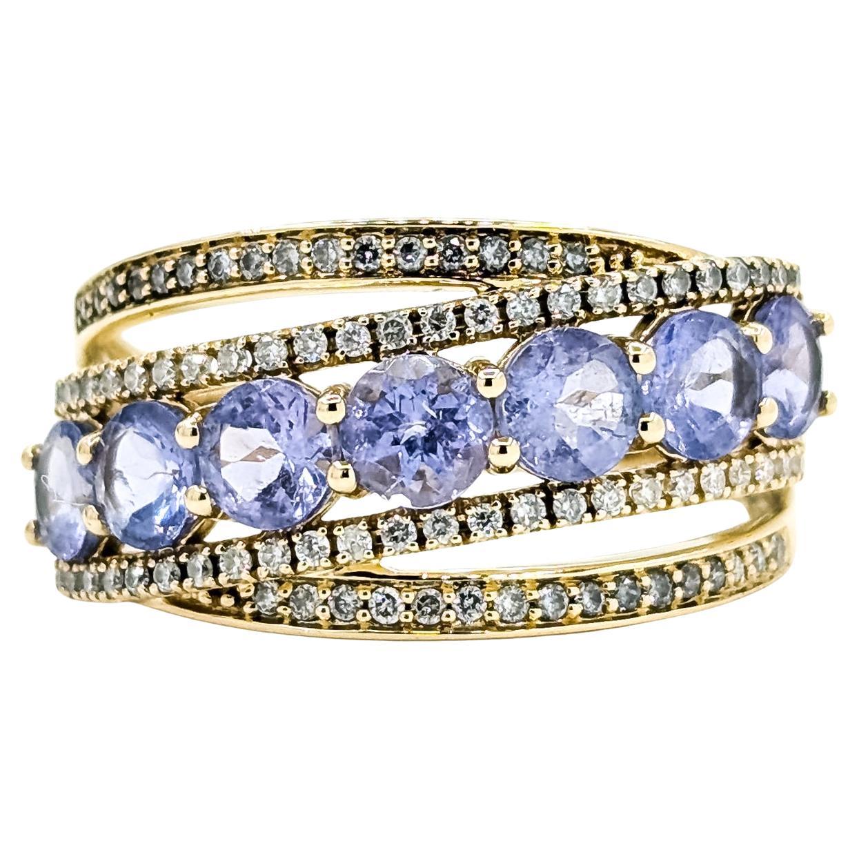 Anello con tanzanite e diamanti incrociati radianti in 14 carati