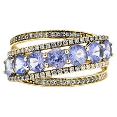 Anello con tanzanite e diamanti incrociati radianti in 14 carati