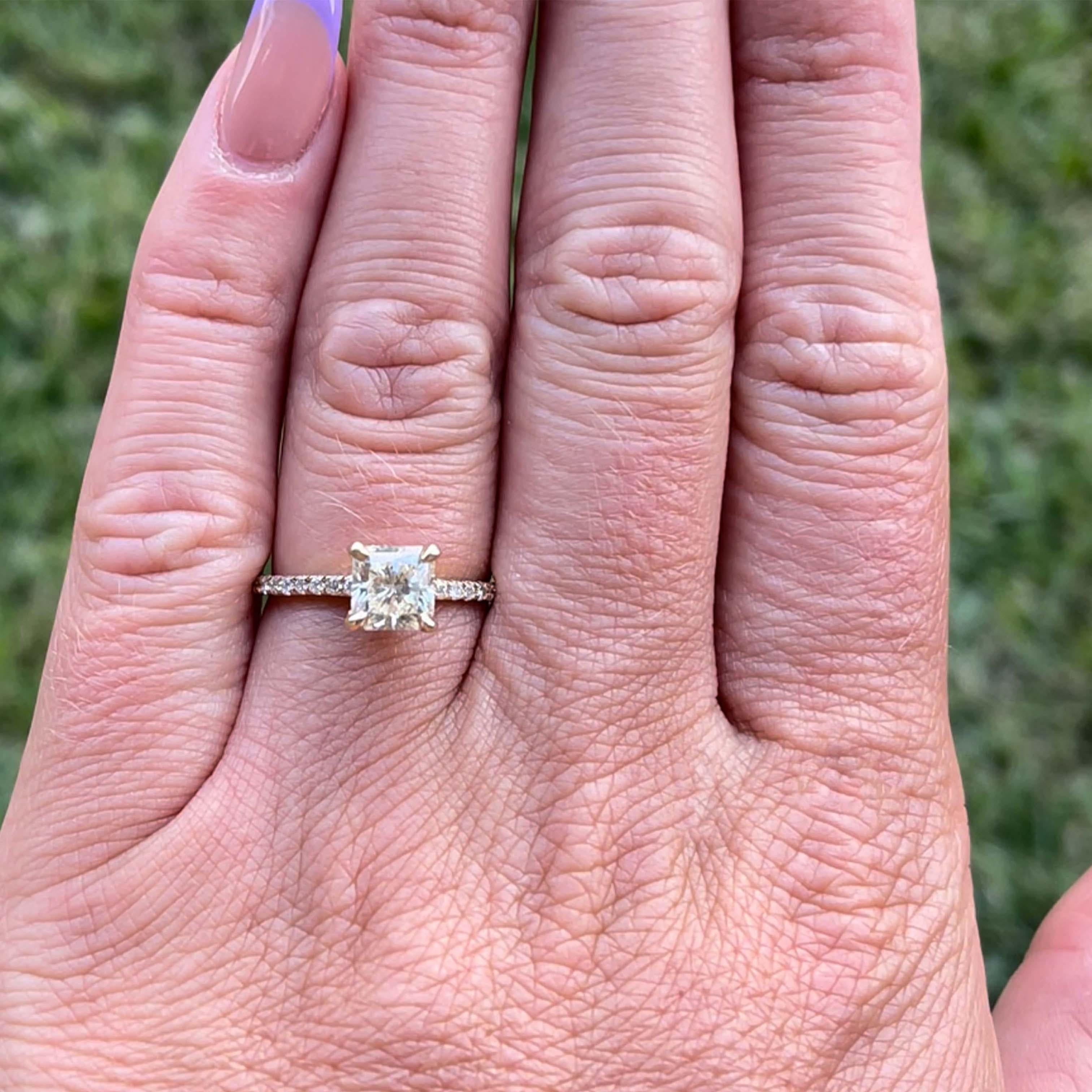 Radiant Cut 1.23 Carat Center Stone Diamond Engagement Ring - 14k Yellow Gold. The 1.23 carat center stone on this beautiful engagement ring is N in color and SI1 in clarity. The ring has an additional 20 diamonds on the shank, 10 on each shoulder