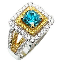 Radiant Cut Blue Zircon, White and Fancy Yellow Diamond Halo Ring in 18k Gold