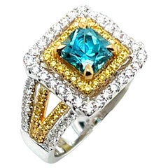 Radiant Cut Blue Zircon, White and Fancy Yellow Diamond Halo Ring in 18k Gold
