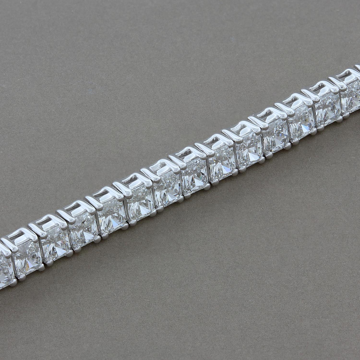 A modern tennis bracelet featuring 9.06 carats of VS quality diamonds. Each radiant cut diamond matching in color and prong set in 18K white gold. The box clasp closure with safety latch ensure for a secure closure.

Fits wrists up to 7 ¼ inches

