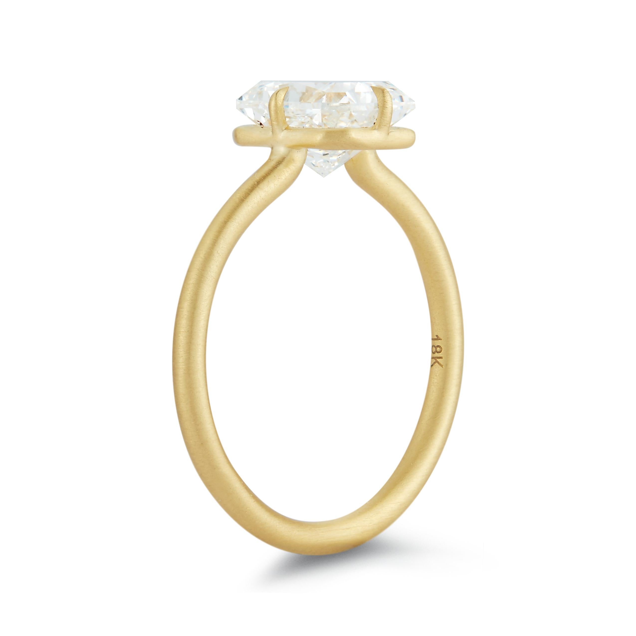 A radiant cut diamond shines without any distraction from the setting. The prongs are shaped to a sharp claw point while there is a beautiful simplicity in the band.