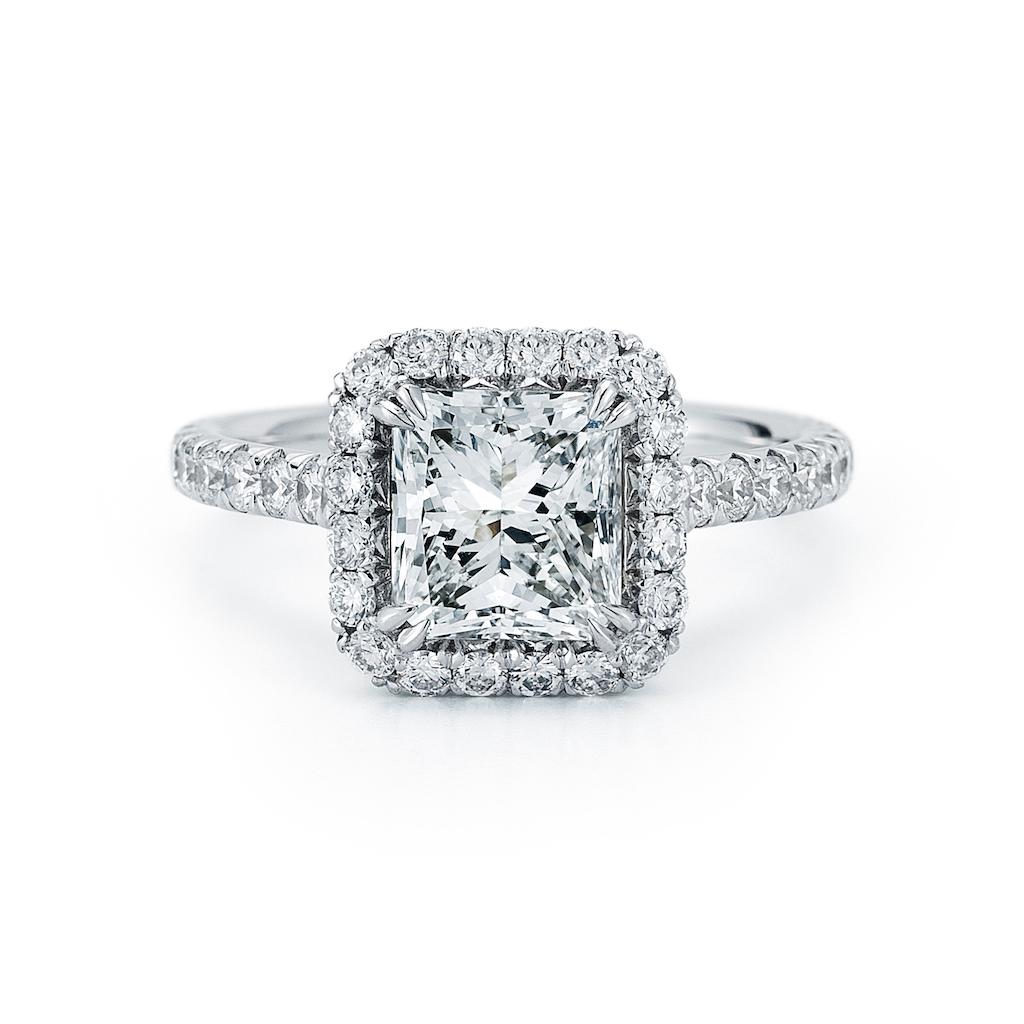 This diamond ring features a radiant cut center stone in a halo setting and a pave band. Review our diamonds in stock and we will be happy to create a ring with a diamond of our choice. Speak to one of our online representatives to learn more how to