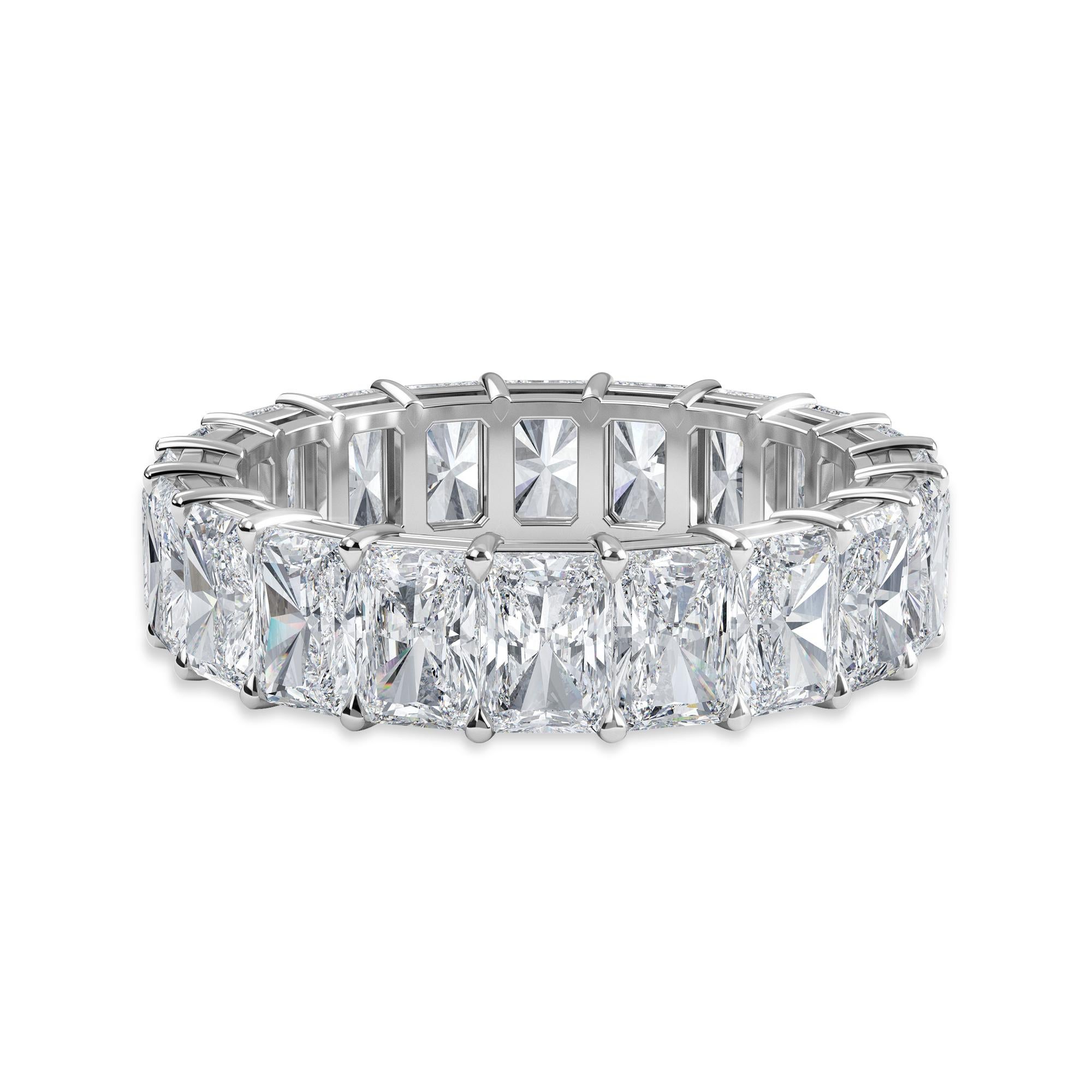 This Radiant Eternity Band features 20 Radiant Diamonds, weighing 6.20 Total Carat Weight. The stones are F Color, and VS Clarity. This ring is set in Platinum, in a shared prong, comfort fit setting. 