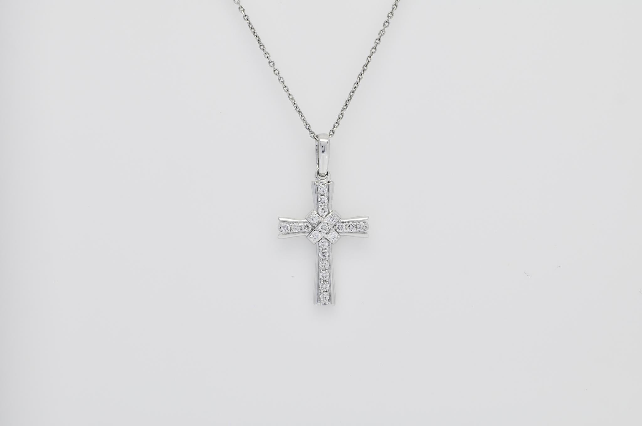 Experience the divine radiance of our exquisite Cross Pendant, a true testament to faith and beauty. Crafted in 18K white gold, this pendant embodies the perfect harmony between elegance and spirituality. Adorned with a collection of natural
