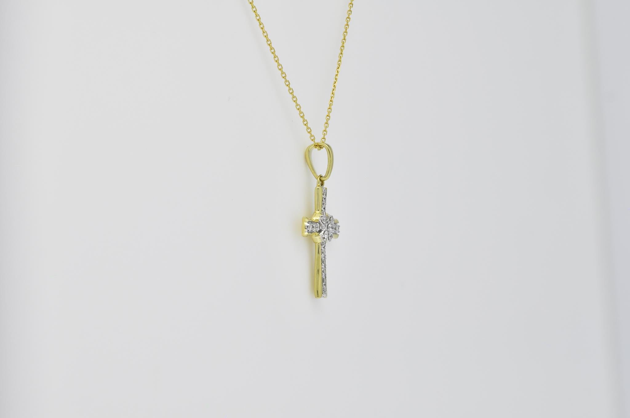 Experience the divine radiance of our exquisite Cross Pendant, a true testament to faith and beauty. Crafted in 18K yellow gold, this pendant embodies the perfect harmony between elegance and spirituality. Adorned with a collection of natural