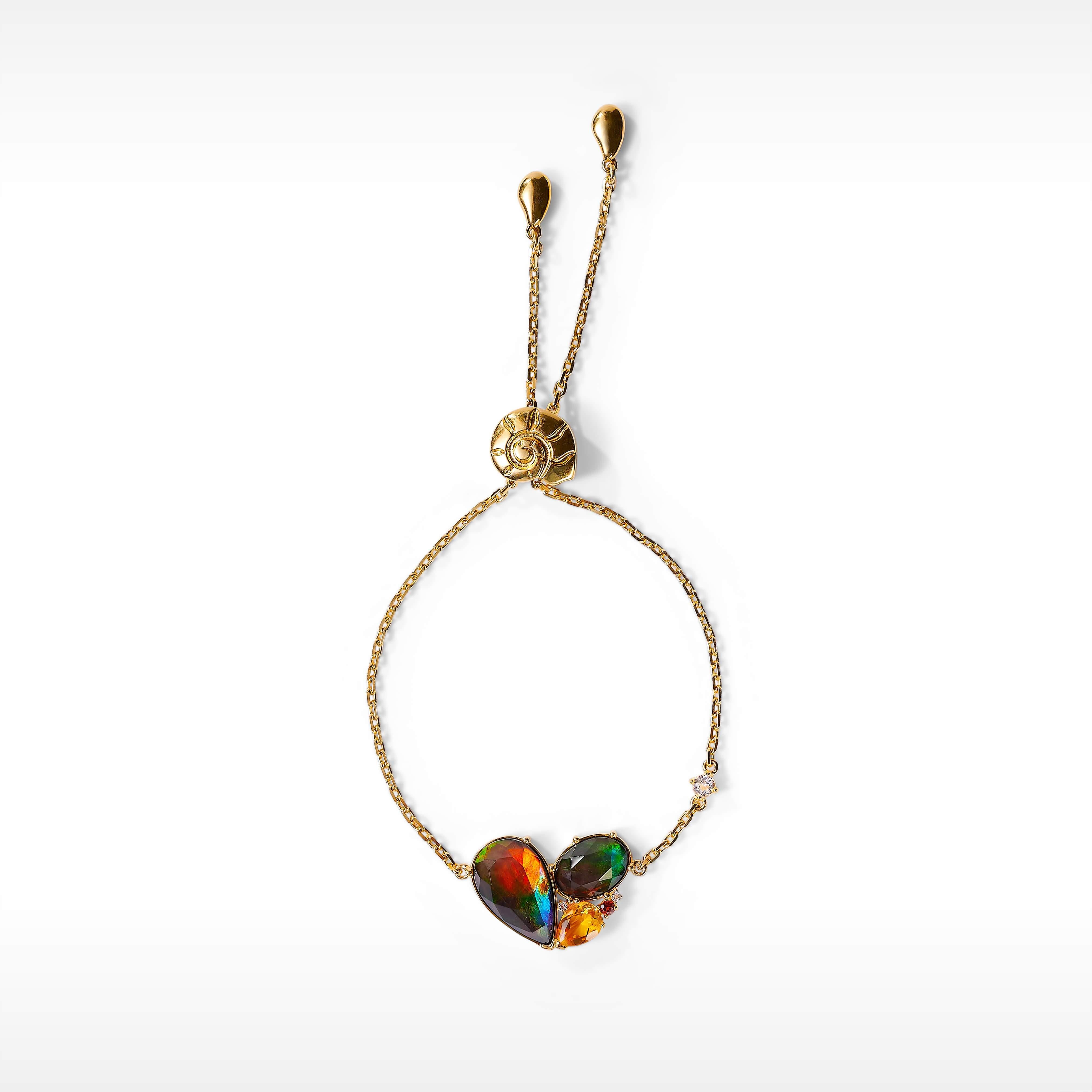 The Radiant collection features striking ammolite clustered with citrine, garnet and white topaz in a celebration of festive gathering seasons.

AA grade Ammolite
9.1mm x 15mm pear and 7.1mm x 10mm oval Ammolite bracelet
18K gold vermeil
Accented