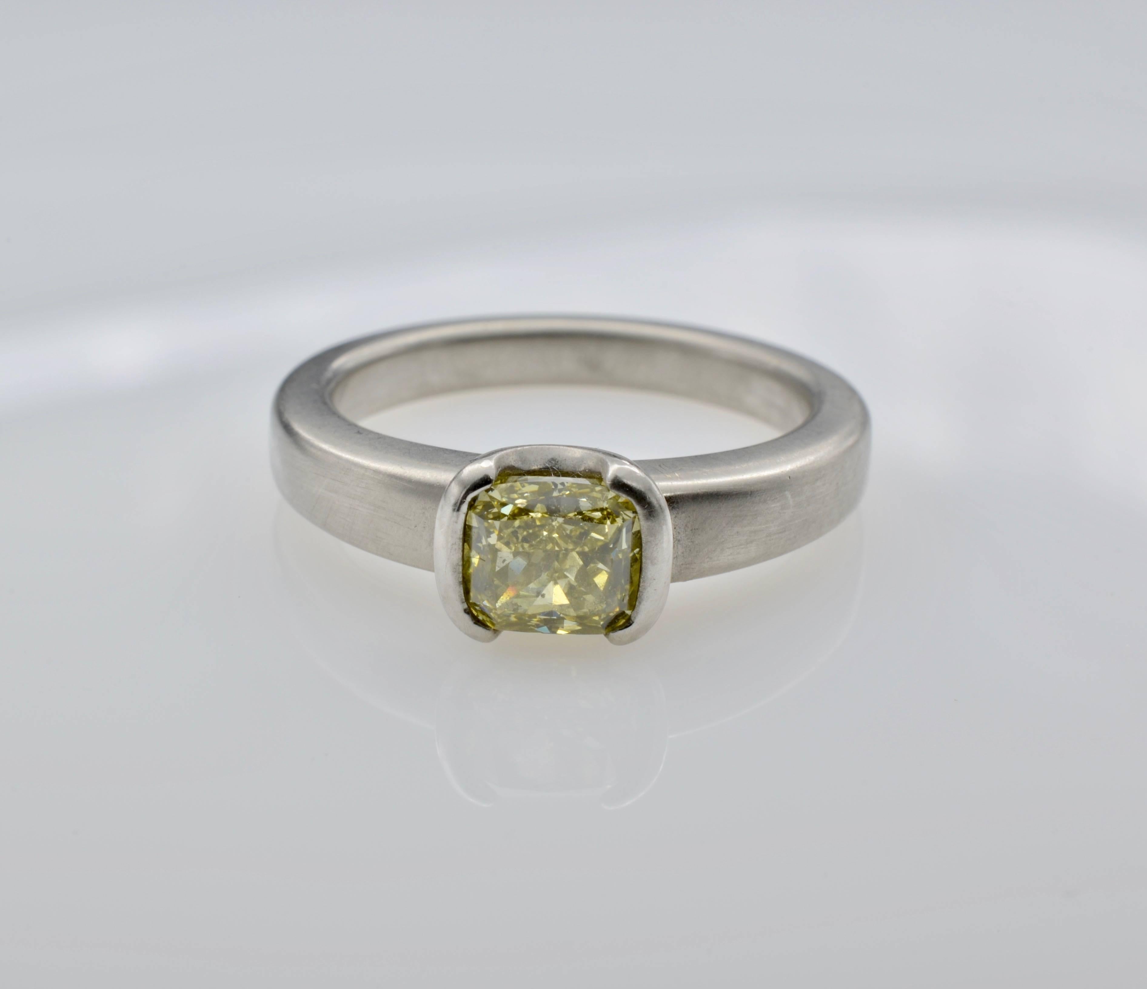 This bright lemon yellow radiant cut diamond ring is set in a satin finished slightly tapered platinum band. Sparkles galore in this bright 0.93 carat diamond ring with a brilliant contrast of soft warm platinum and mouth watering lemon yellow