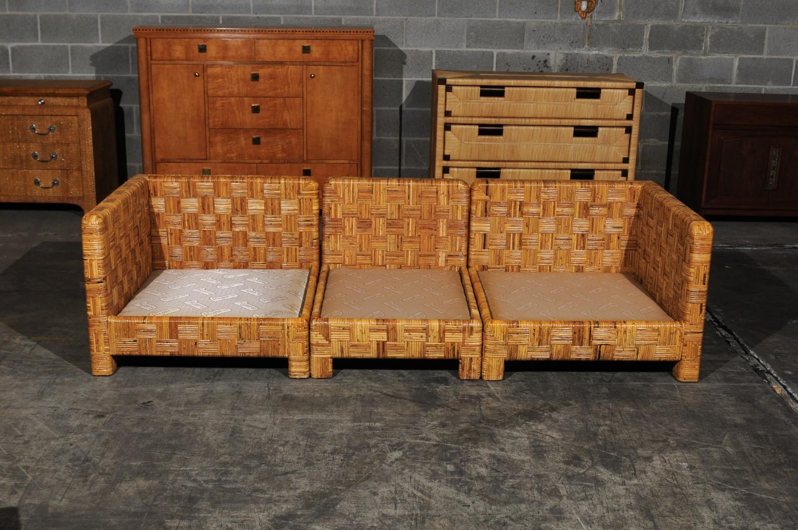A stunning restored Billy Baldwin style Parsons three-seat sofa, circa 1975. Elegant hardwood form, painstakingly veneered in basketweave cane. Exceptional quality and craftsmanship. The set may also be arranged to use as a two-seat loveseat and a