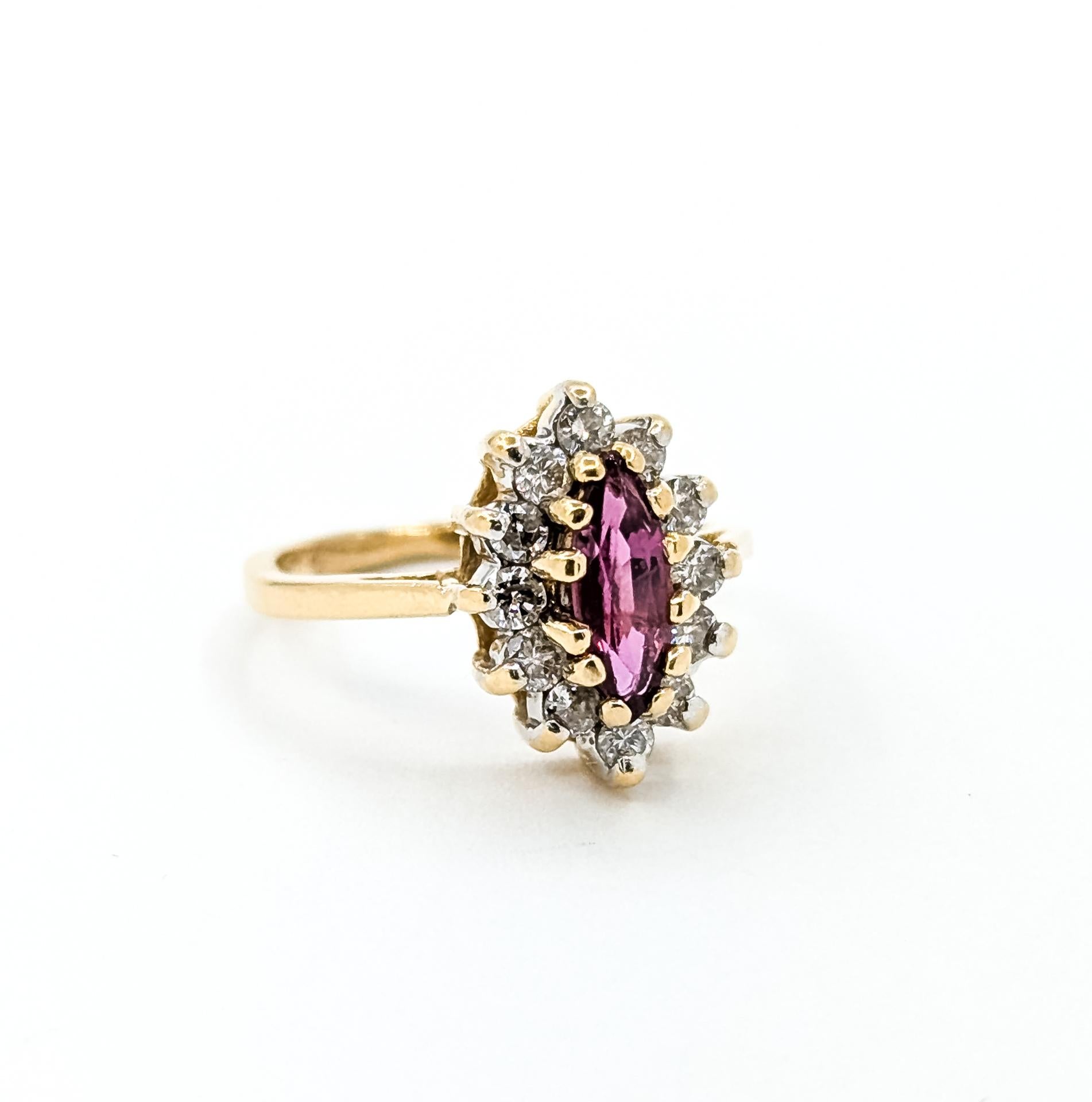This elegant ring is crafted in 14k yellow gold and features a 0.38-carat marquise-cut ruby surrounded by a halo of round brilliant diamonds totaling 0.24 carats. The ruby’s vivid red hue is beautifully complemented by the near-colorless diamonds,
