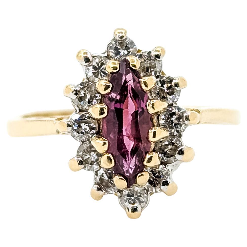 Anello a raggiera con rubino e diamanti in 14 carati