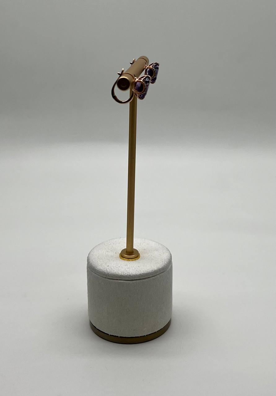 A striking pair of 21st Century earrings  featuring vibrant purple amethysts set in a sleek gold setting. 14K Rose Gold. 0.20 CTW Diamonds. 4.40 CTW Amethysts.