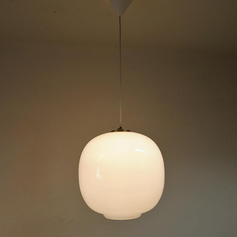 This opaline glass pendant lamp is the same model as the original radio house pendant from the 1940s named VL45 Radiohus Pendel. The Radiohus pendel was created in conjunction with the Radiohouse in Copenhagen. The author was Vilhelm Lauritzen, one
