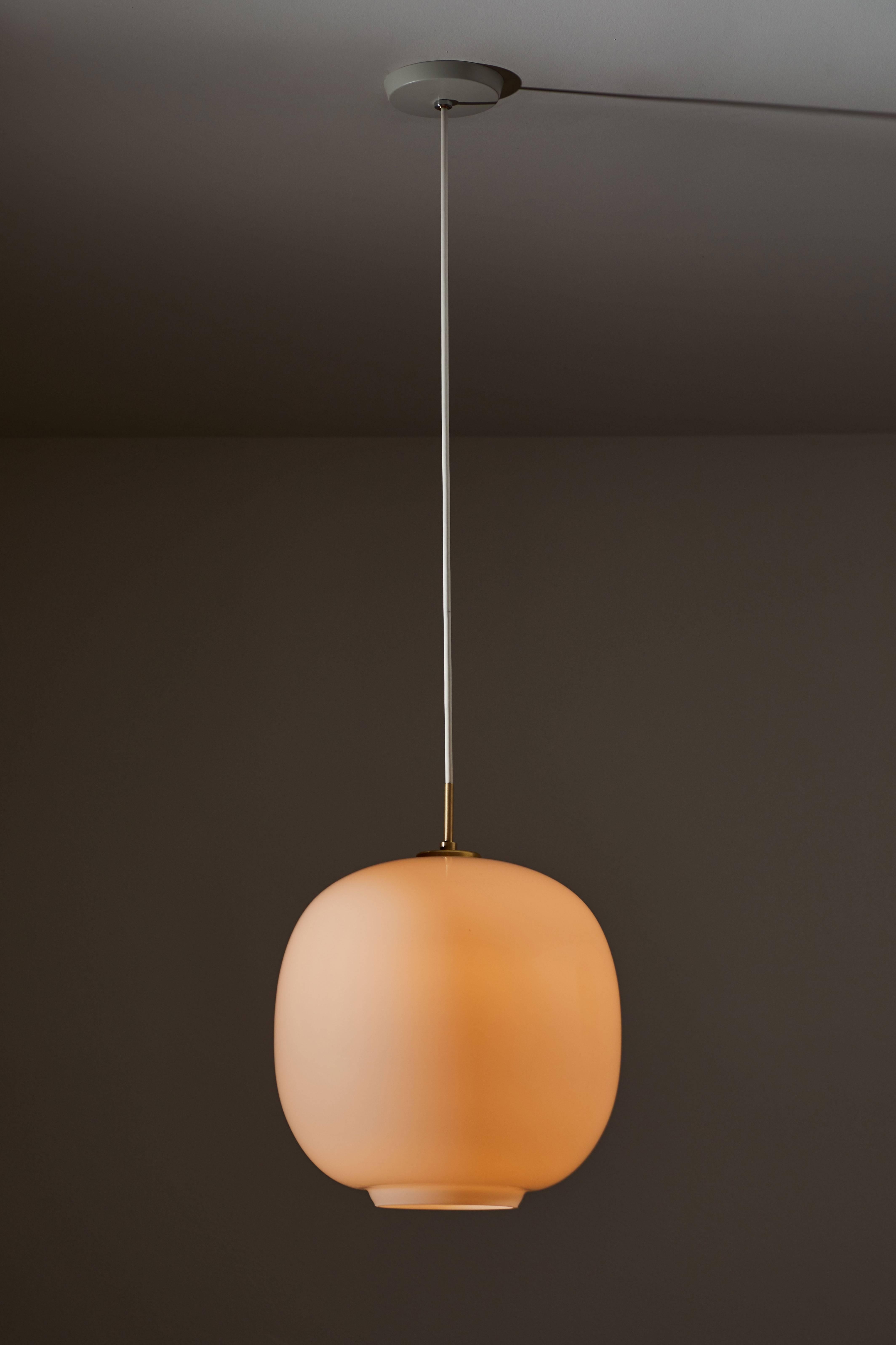 Large Radiohus VL45 Pendant by Vilhelm Lauritzen for Louis Poulsen. Current production designed and manufactured in Denmark. Opaline glass and brass Hardware. Currently, the VL 45 Radiohus Pendant Light is being reintroduced with the same original