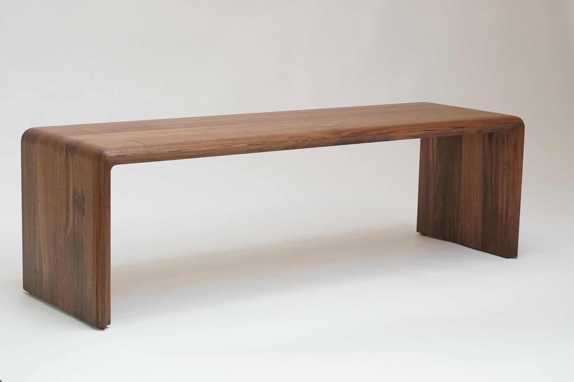 Radiused outer edges and scalloped inner edge create a contrasting profile that adorns this minimal bench. Made from hand oiled solid walnut, this bench blends simple lines with unique subtle details.

Available in walnut, ash, reclaimed southern