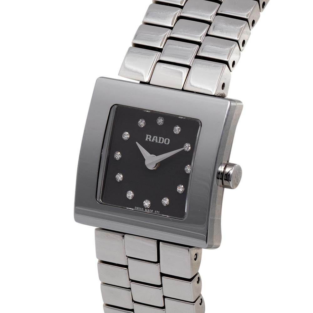 This stunning Rado Diastar wristwatch is perfect to pair with your evening and special outfits. Constructed in stainless steel, this watch features a thick bezel with a black dial styled with stud hour markers and two hands. The bracelet wraps