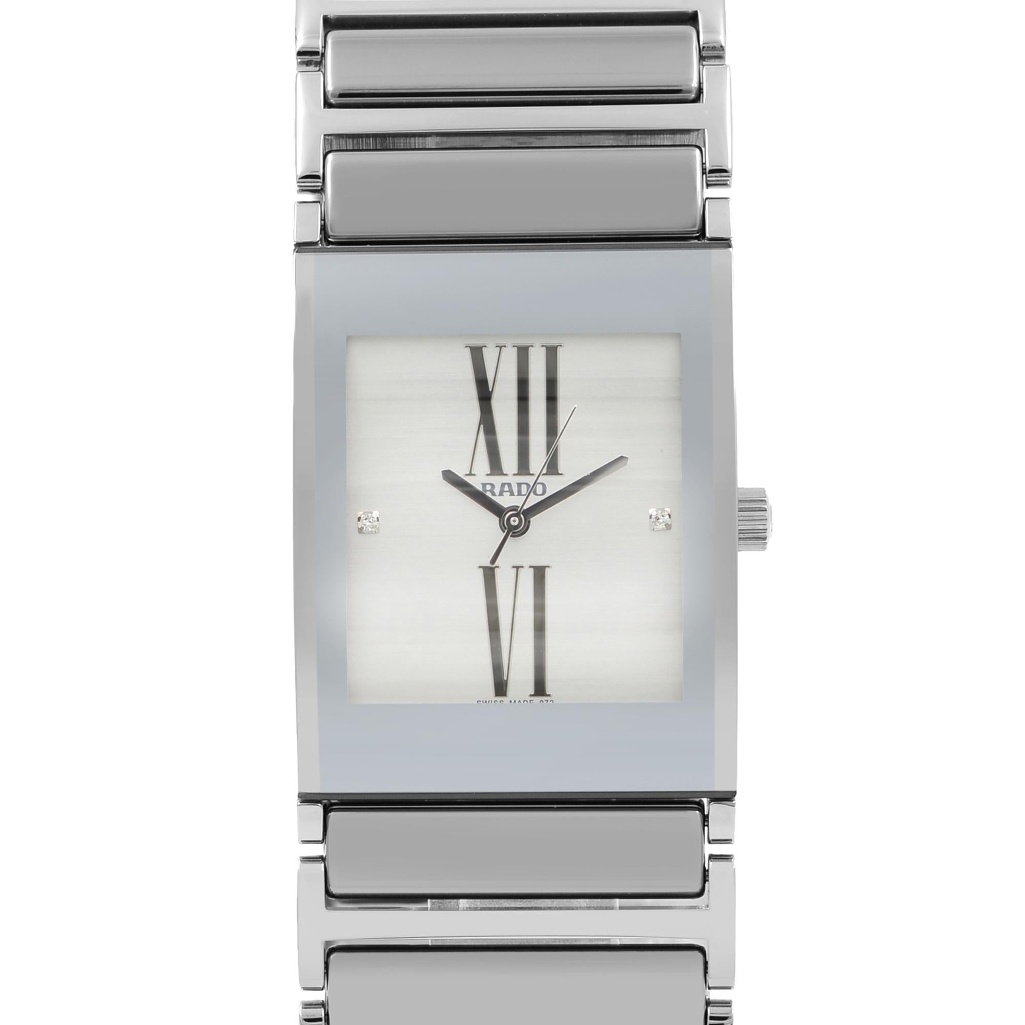 This brand new Rado Integral R20745722 is a beautiful Ladies timepiece that is powered by a quartz movement which is cased in a stainless steel case. It has a  rectangle shape face,  dial and has hand sticks & numerals style markers. It is completed