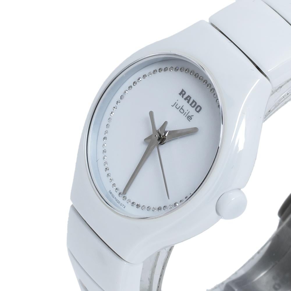 This watch from the house of Rado features a white dial set with diamonds around the outer rim. The 27 MM high tech ceramic case features a fixed bezel and is held by a high tech ceramic and titanium bracelet. The quartz movement and water