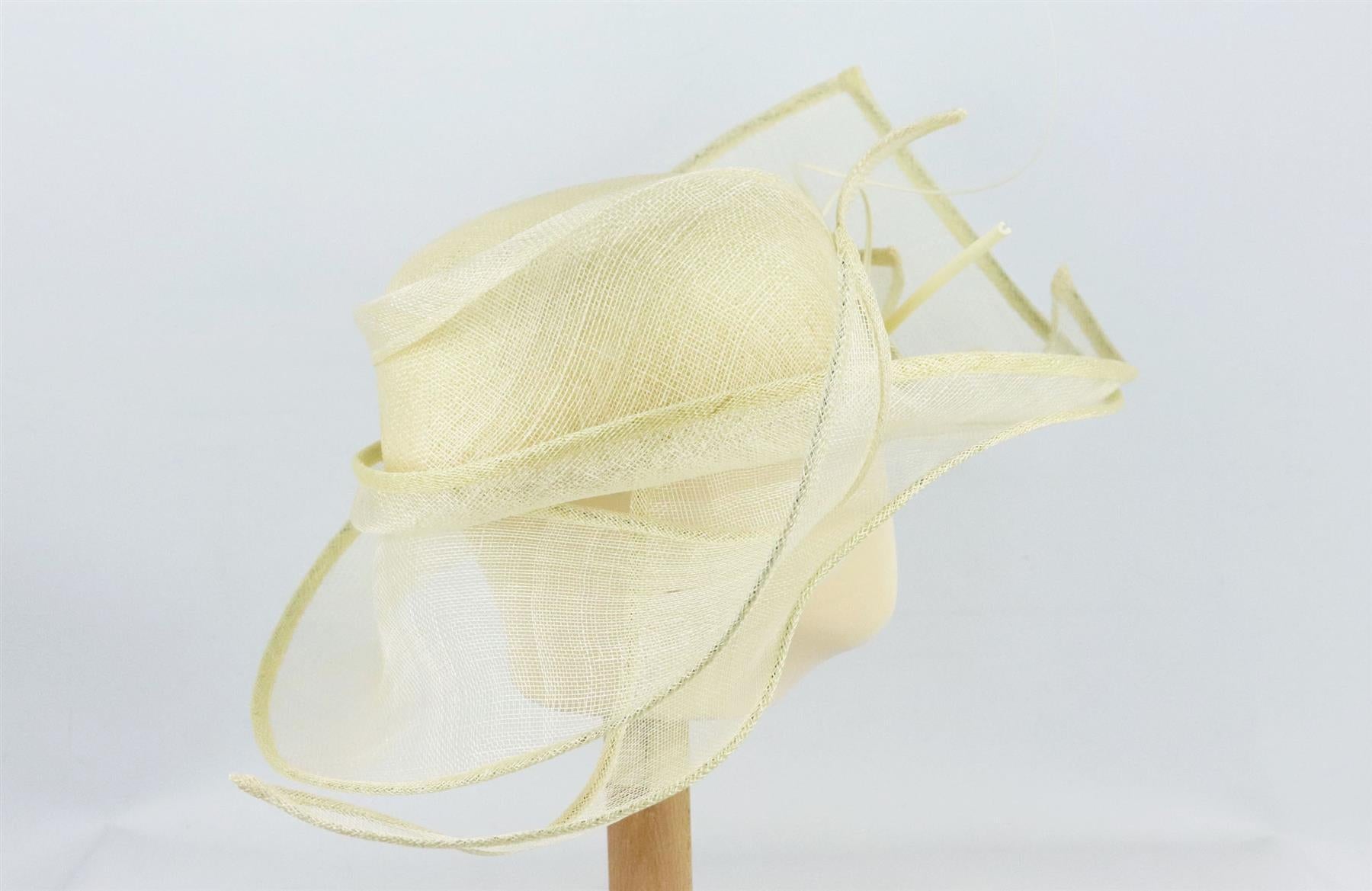 This hat by Rae Oakley is made from cream sinamay straw in a structured sweeping silhouette and finished with a bow detail along the front. Cream straw. Slips on. 100% Straw. Comes with box. Dimensions: H 6.5 x W 23 inches. Circumference: 21.3