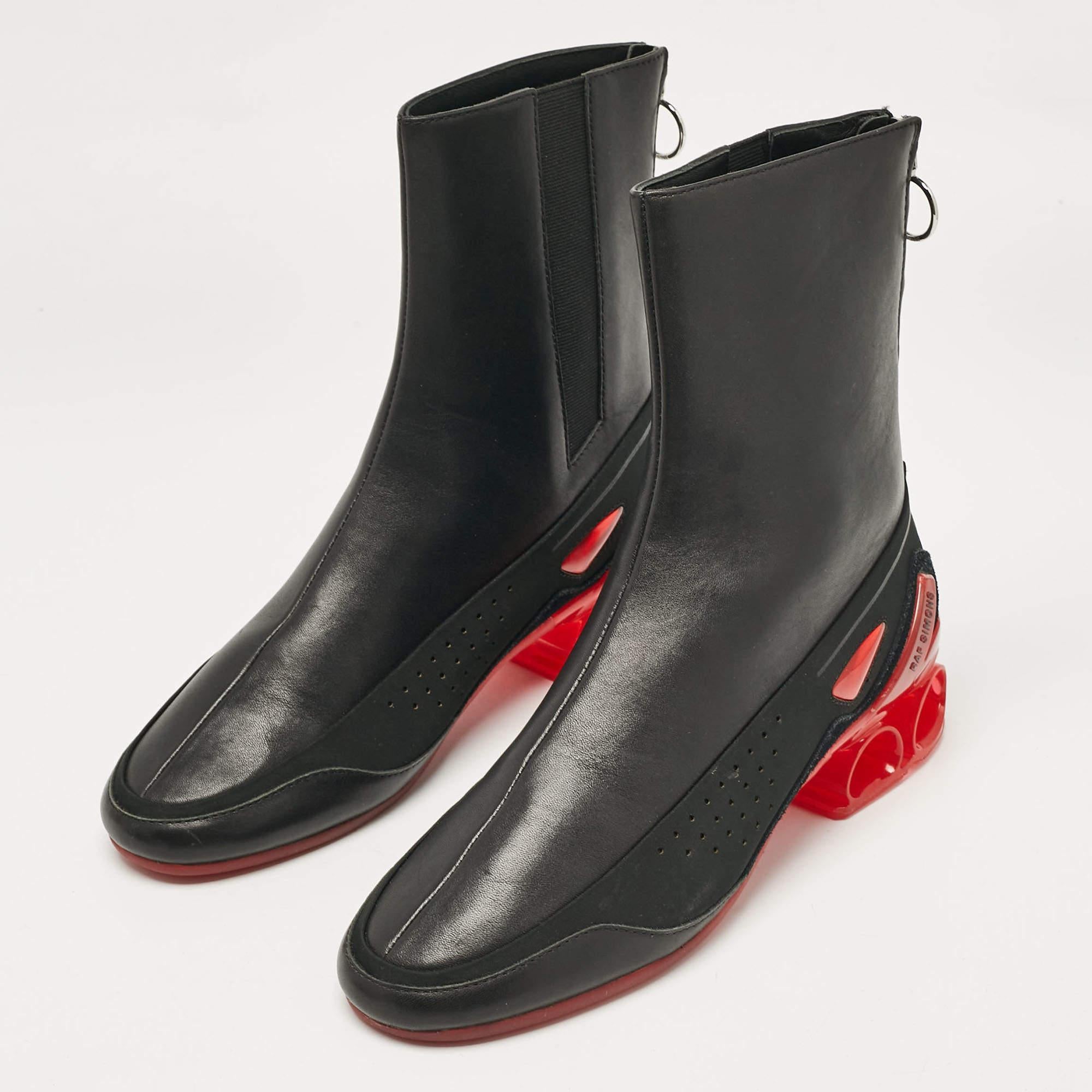 Raf Simons black leather ankle length boots offer a sleek  modern design crafted from premium leather. These boots feature a smooth finish  rounded toes  and subtle stitching details  providing a minimalist yet sophisticated look. With a comfortable