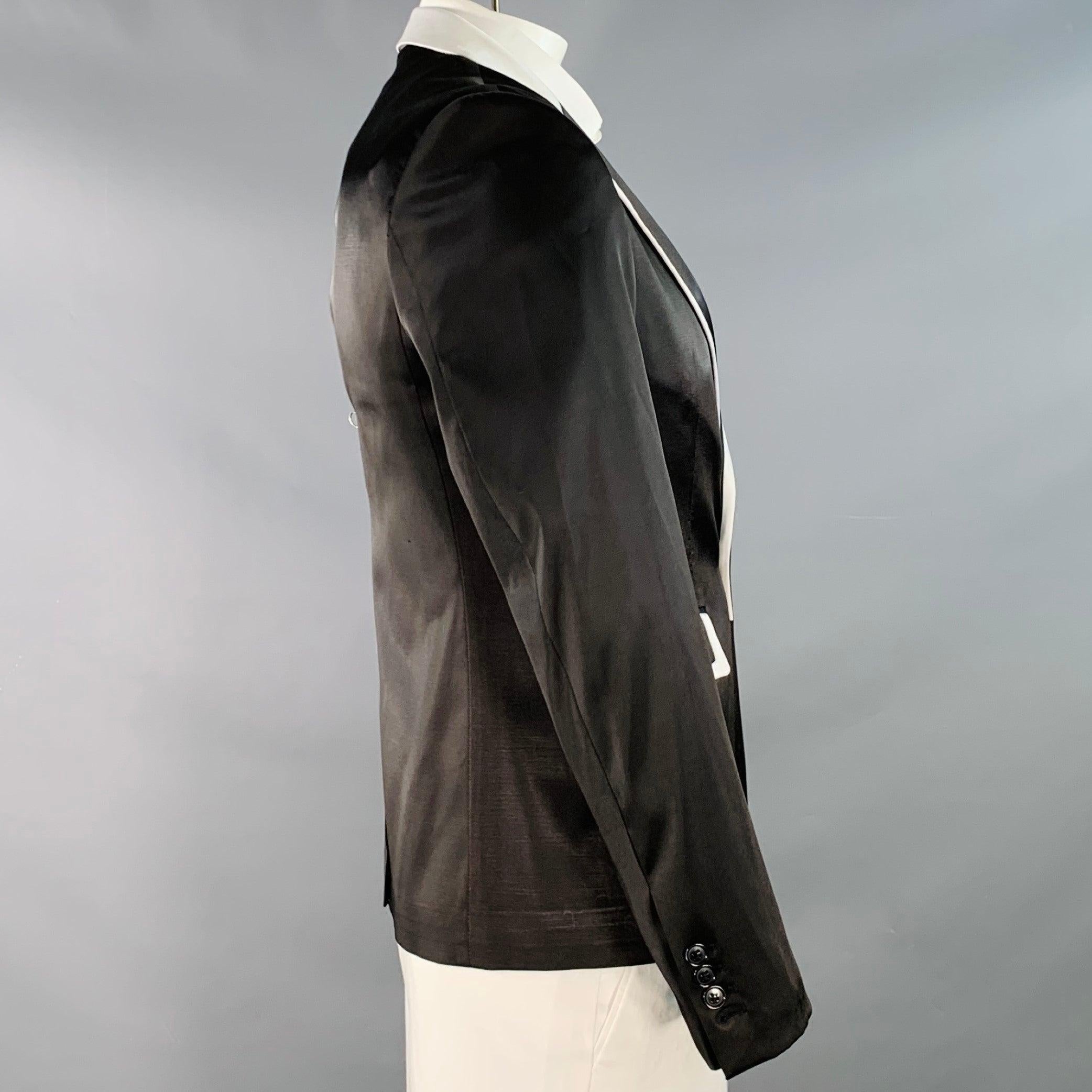 RAF SIMONS sport coat
in a black and white wool acrylic satin fabric featuring a contrast trim, peak lapel, single vented back, and single button closure. Made in France.Good Pre-Owned Condition. Moderate signs of wear, as is. 

Marked:   4