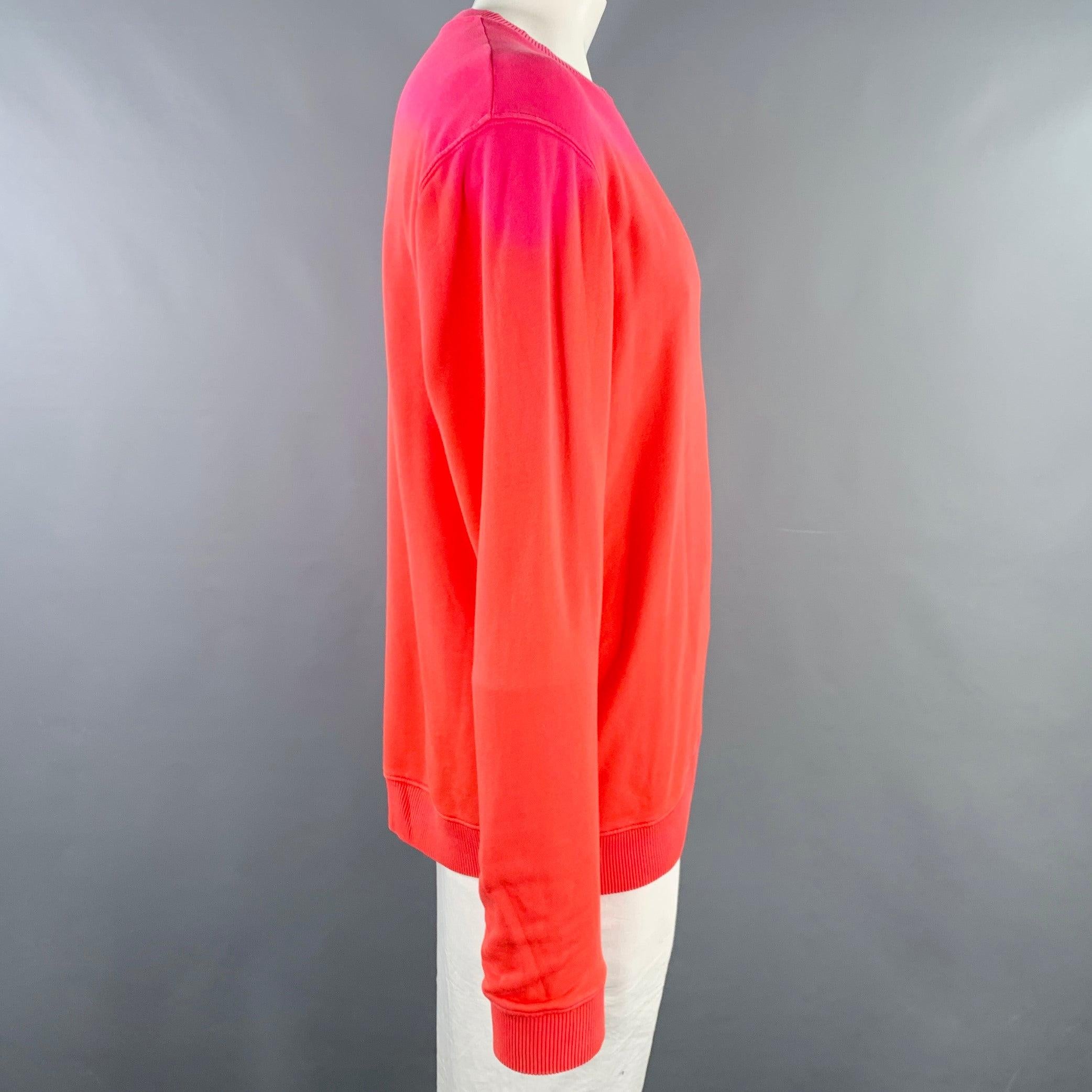 RAF SIMONS sweatshirt
in a pink and orange cotton jersey featuring an ombre pattern, long sleeves, and crew neck. Made in Portugal.Very Good Pre-Owned Condition. Minor marks on shoulder. 

Marked:   XL 

Measurements: 
 
Shoulder: 23 inches Chest: